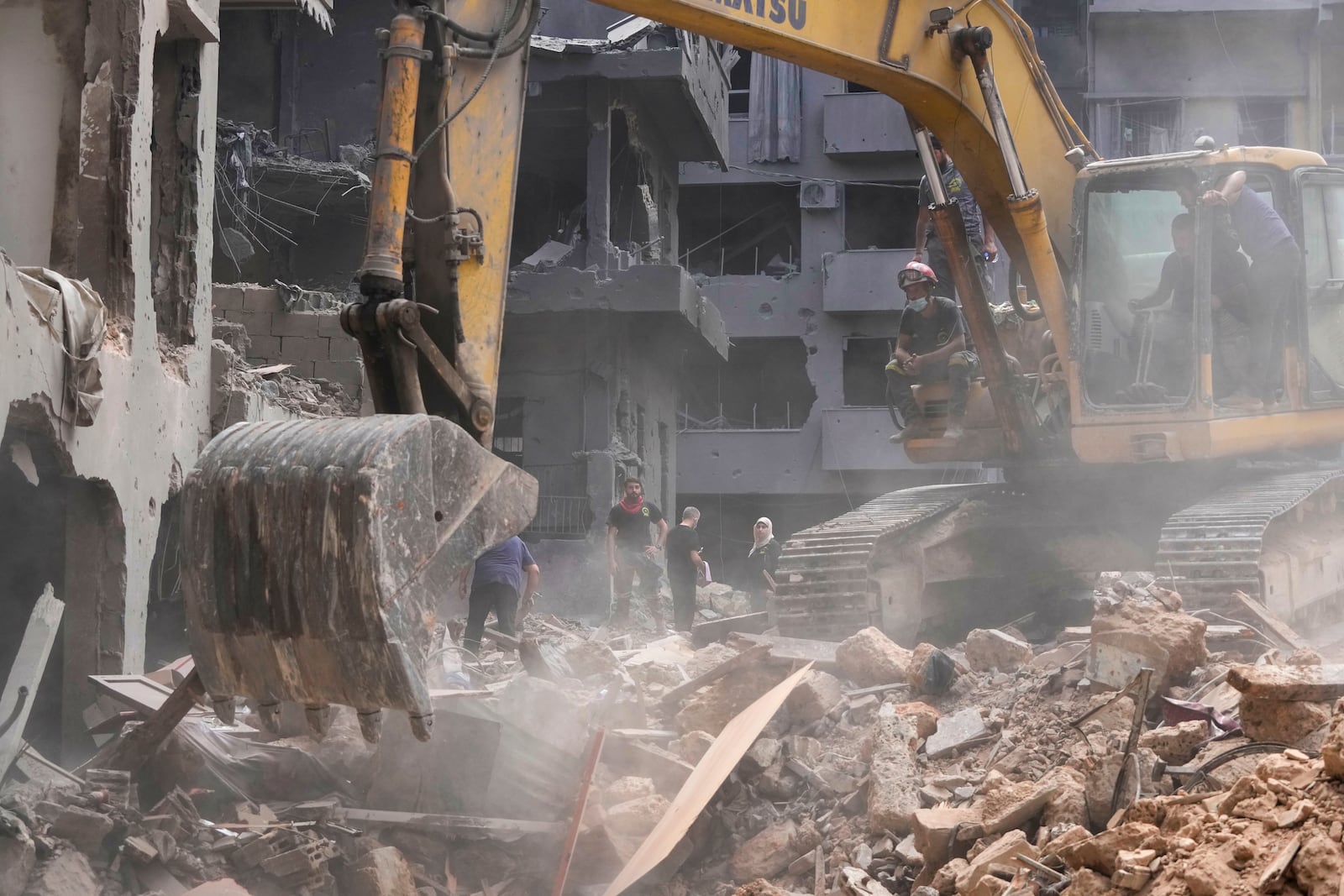 Rescue workers keep searching for victims at the site of Thursday's Israeli airstrike in Beirut, Lebanon, Saturday, Oct. 12, 2024. (AP Photo/Hassan Ammar)