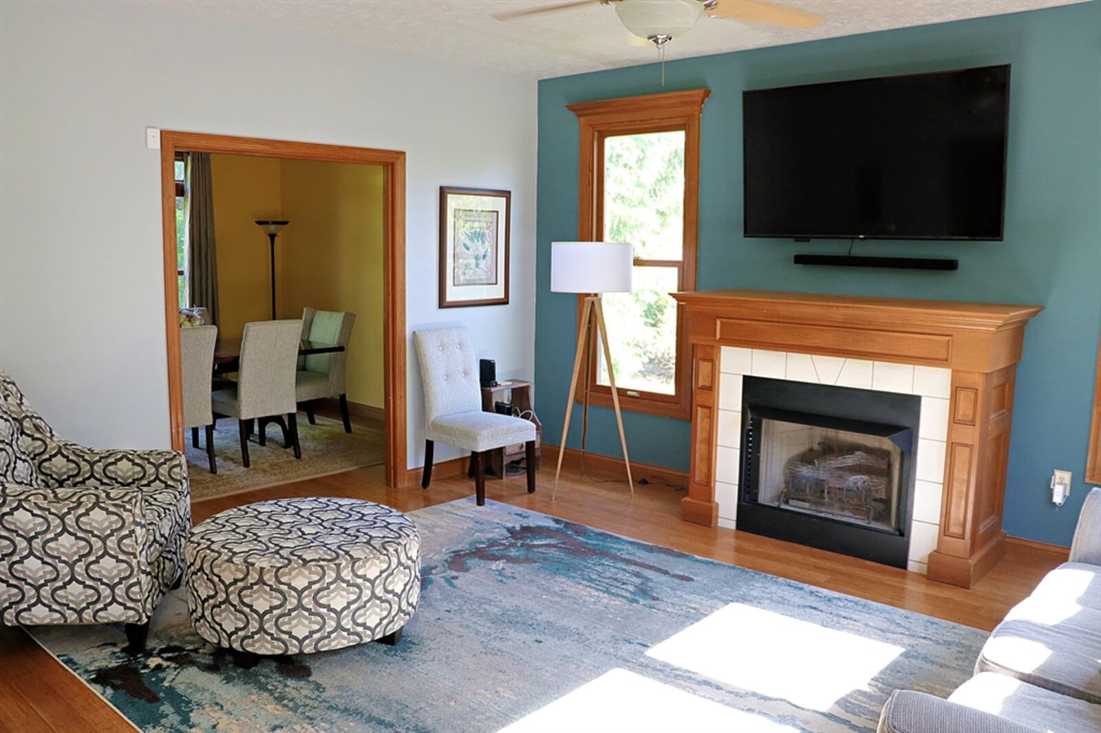 Windows flank an electric fireplace, which is the centerpiece to the family room.