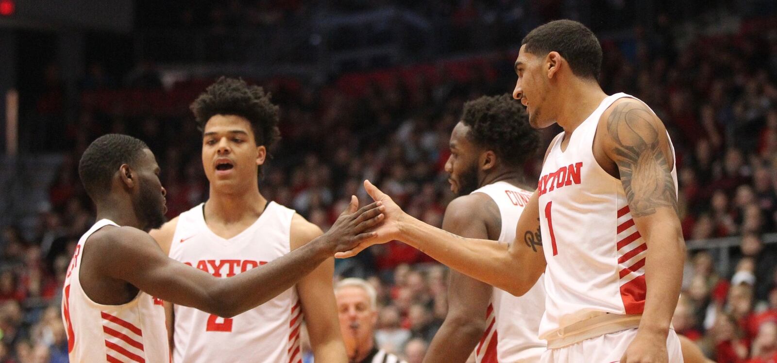 Dayton’s Dwayne Cohill and Obi Toppin slap hands after a score against Saint Joseph’s on Tuesday, Jan. 29, 2019, at UD Arena. David Jablonski/Staff