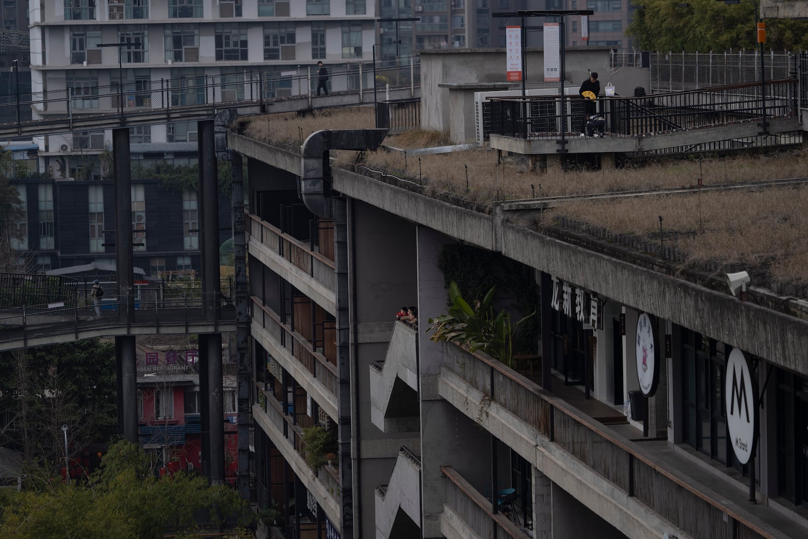 Visitors enjoy the roof top walk way at the West Village project by Pritzker Architecture Prize winner Chinese architect Liu Jiakun in Chengdu in southwestern China's Sichuan province on Sunday, March 2, 2025. (AP Photo/Ng Han Guan)