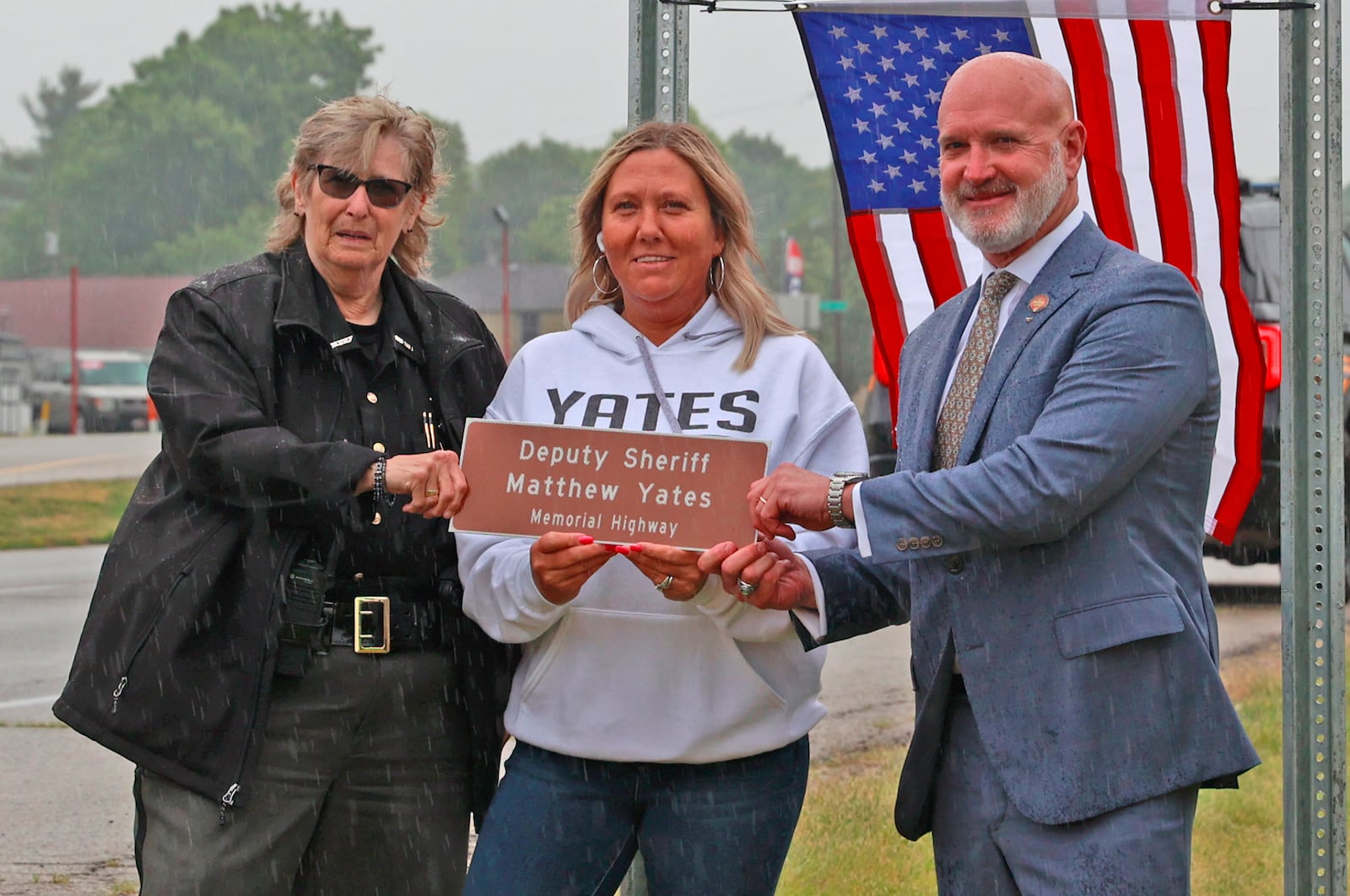 Tracy Yates, the wife of fallen Clark County Sheriff's Deputy Matthew Yates, is presented with a small version of the Deputy Sheriff Matthew Yates Memorial Highway sign by Clark County Sheriff Deb Burchett and State Representative Bernie Willis Tuesday, June 13, 2023. BILL LACKEY/STAFF