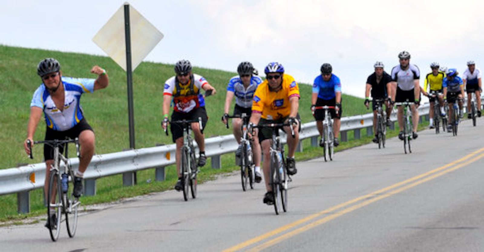 A group of bicycle riders participating in the American Cancer Society's third annual Pan Ohio Hope Ride, make their way along Robert Eastman Road at C.J. Brown Reservoir Saturday, August 1. The noncompetitive statewide cycling tour from Cleveland to Cincinnati ended their third day at Wittenberg University's Firestone Hall were they will spend the night before finishing Sunday. The funds raised by the 220 "Hope Riders" benefits the American Canc