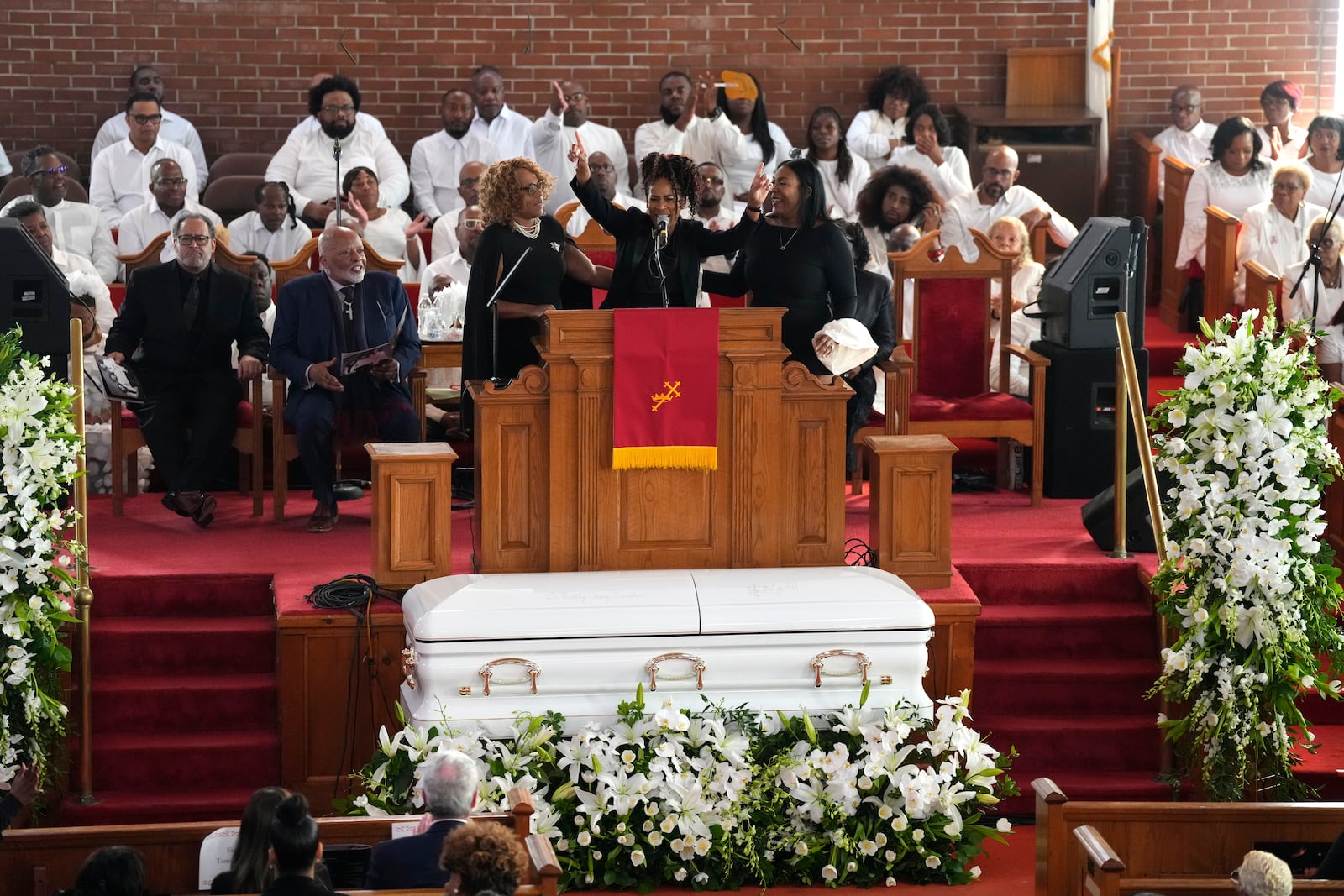 Tawanna Brown, from left, Fatima Jones, and Tiffany Summerville appear during a ceremony celebrating the life of Cissy Houston on Thursday, Oct. 17, 2024, at the New Hope Baptist Church in Newark, N.J. (Photo by Charles Sykes/Invision/AP)