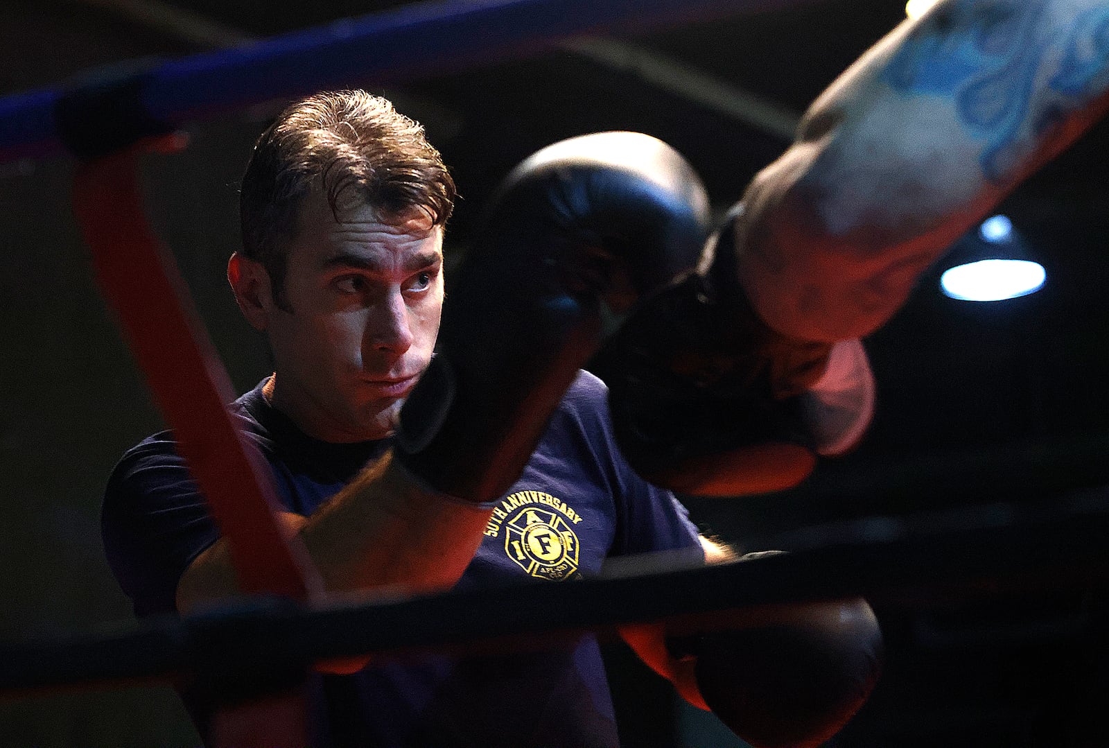 Xenia firefighter Warren Roberds, left, trains at Drake's Downtown Gym in Dayton ahead of the Dawg Fight charity exhibition tournament next Thursday. MARSHALL GORBY\STAFF