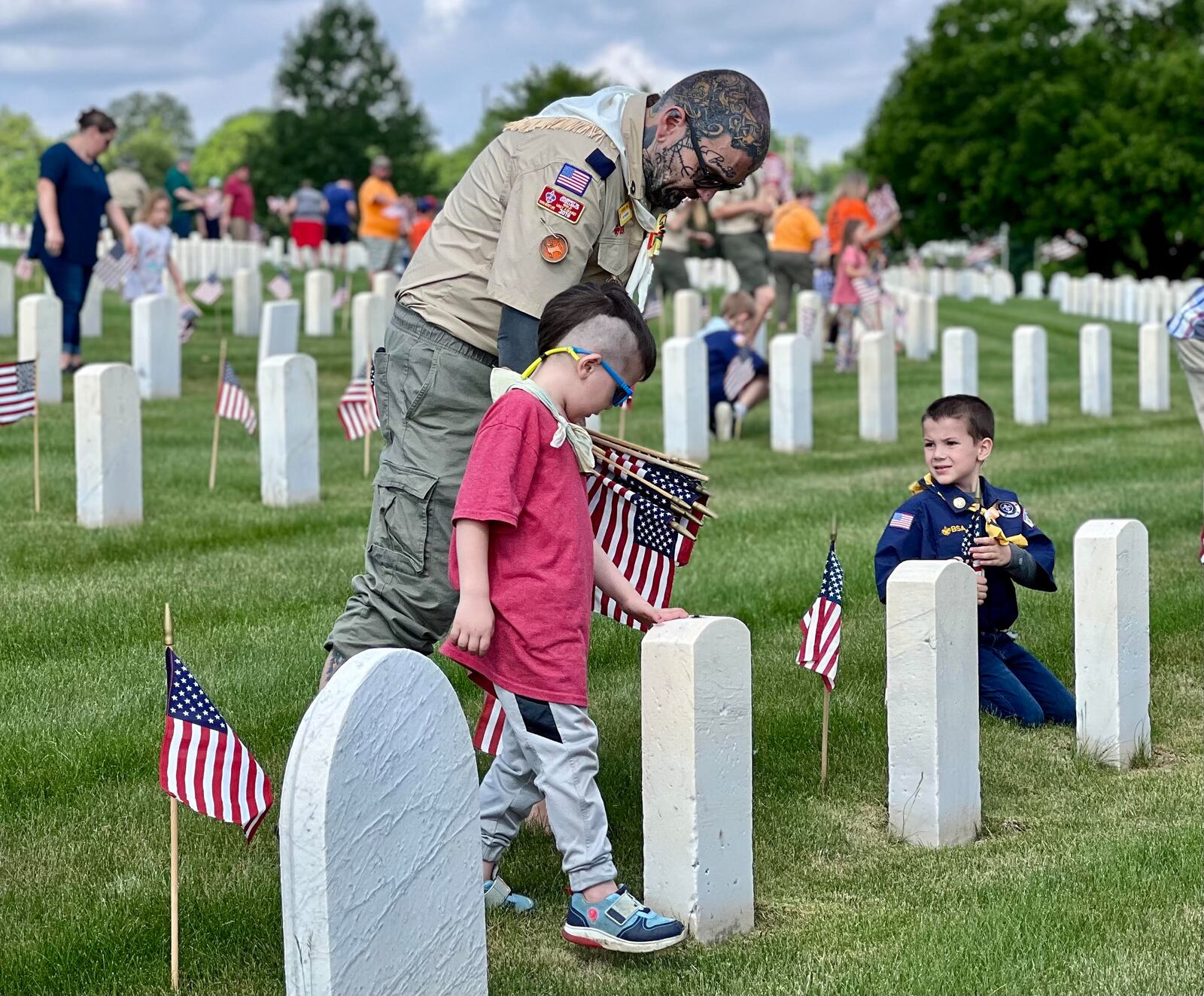 Boy and Girl Scout troops posted American flags at each grave within the Dayton National Cemetery located at the Veterans Medical Center on Saturday. AIMEE HANCOCK/STAFF