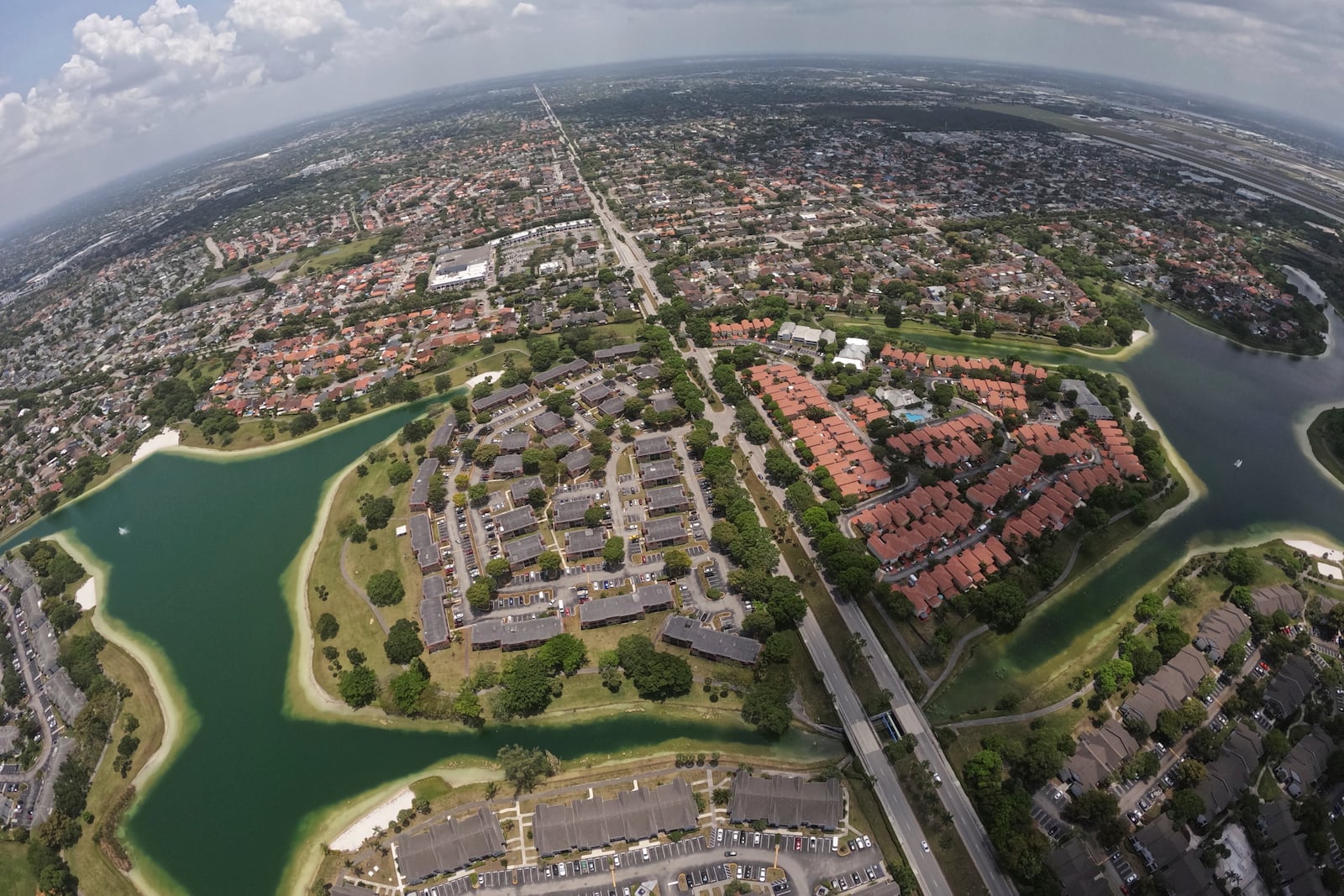 Housing developments are seen amid artificial lakes on the western side of Miami, Friday, May 17, 2024, during a flight donated by LightHawk over parts of the vast Everglades ecosystem in southern Florida. (AP Photo/Rebecca Blackwell)