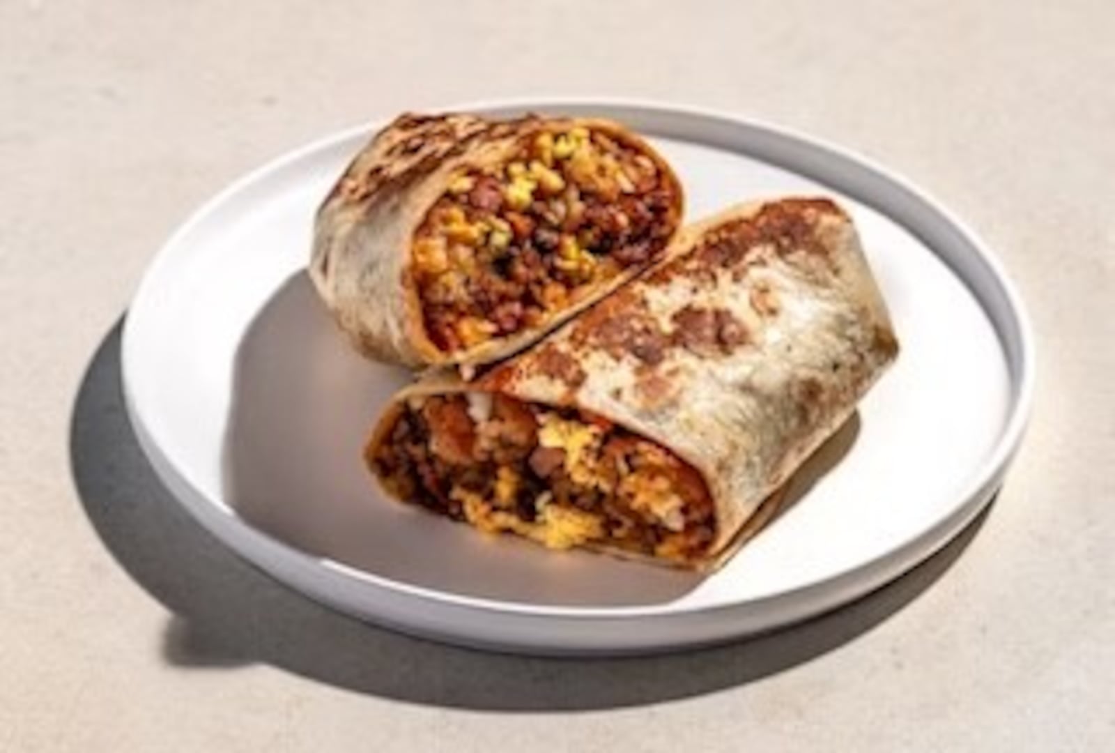 The Morning Meat-Up Burrito at Rusty Taco features scrambled eggs, tater tots, brisket, ground beef, American cheese, sour cream, BBQ sauce and queso fresco wrapped in a flour tortilla (CONTRIBUTED PHOTO).