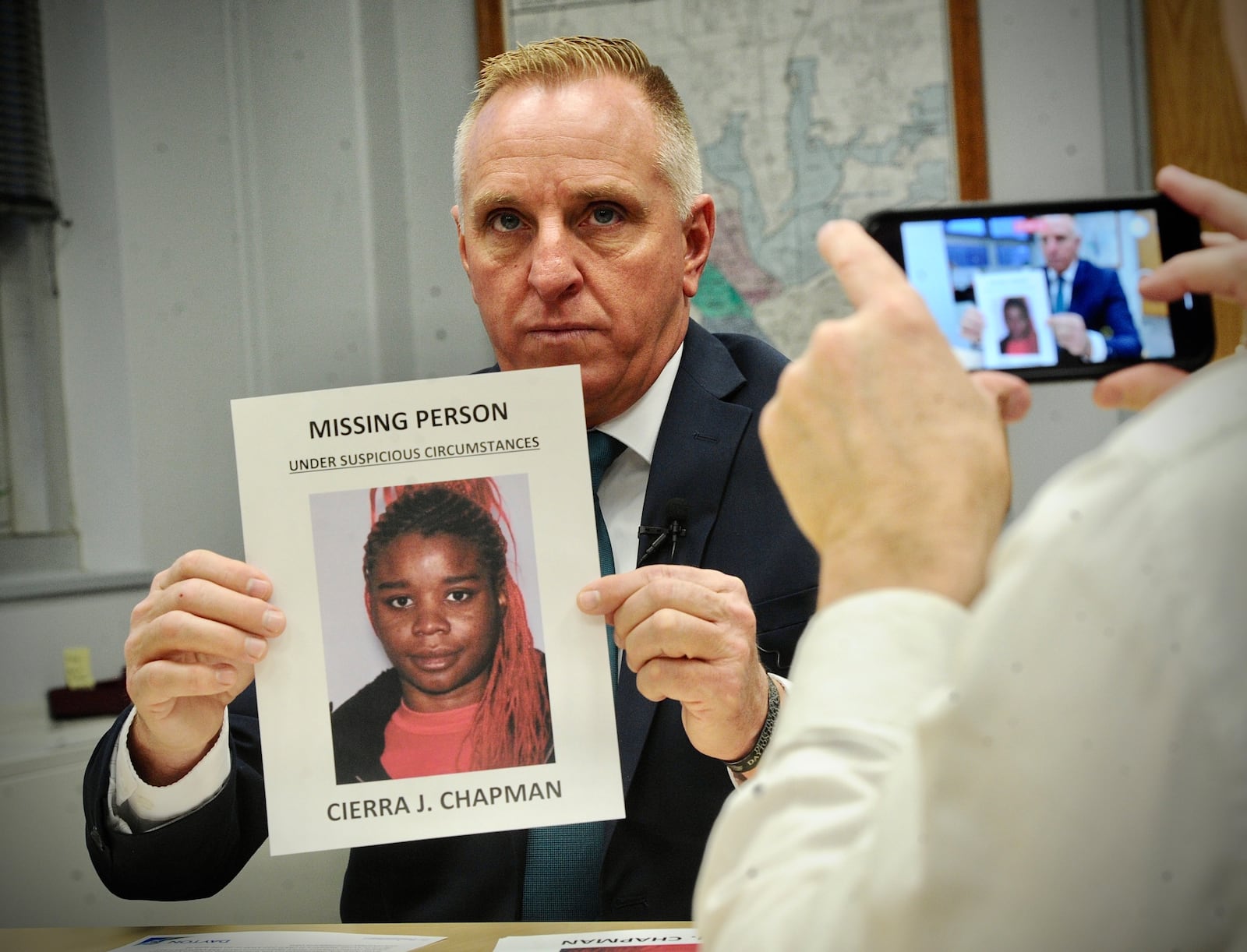 Dayton police Maj. Brian Johns holds up a photo Thursday, Jan. 12, 2023, of Cierra J. Chapman a missing person last seen on Dec. 27, 2022. MARSHALL GORBY \STAFF