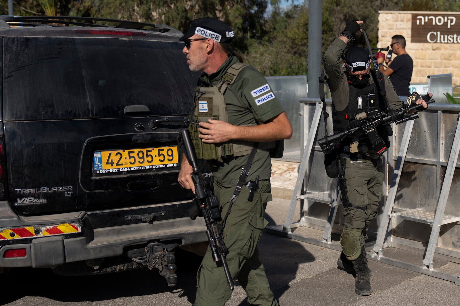 Israeli security forces secure a road near where Israel's government says a drone launched toward Israeli Prime Minister Benjamin Netanyahu's house in Caesarea, Israel Saturday, Oct. 19, 2024. (AP Photo/Ariel Schalit)