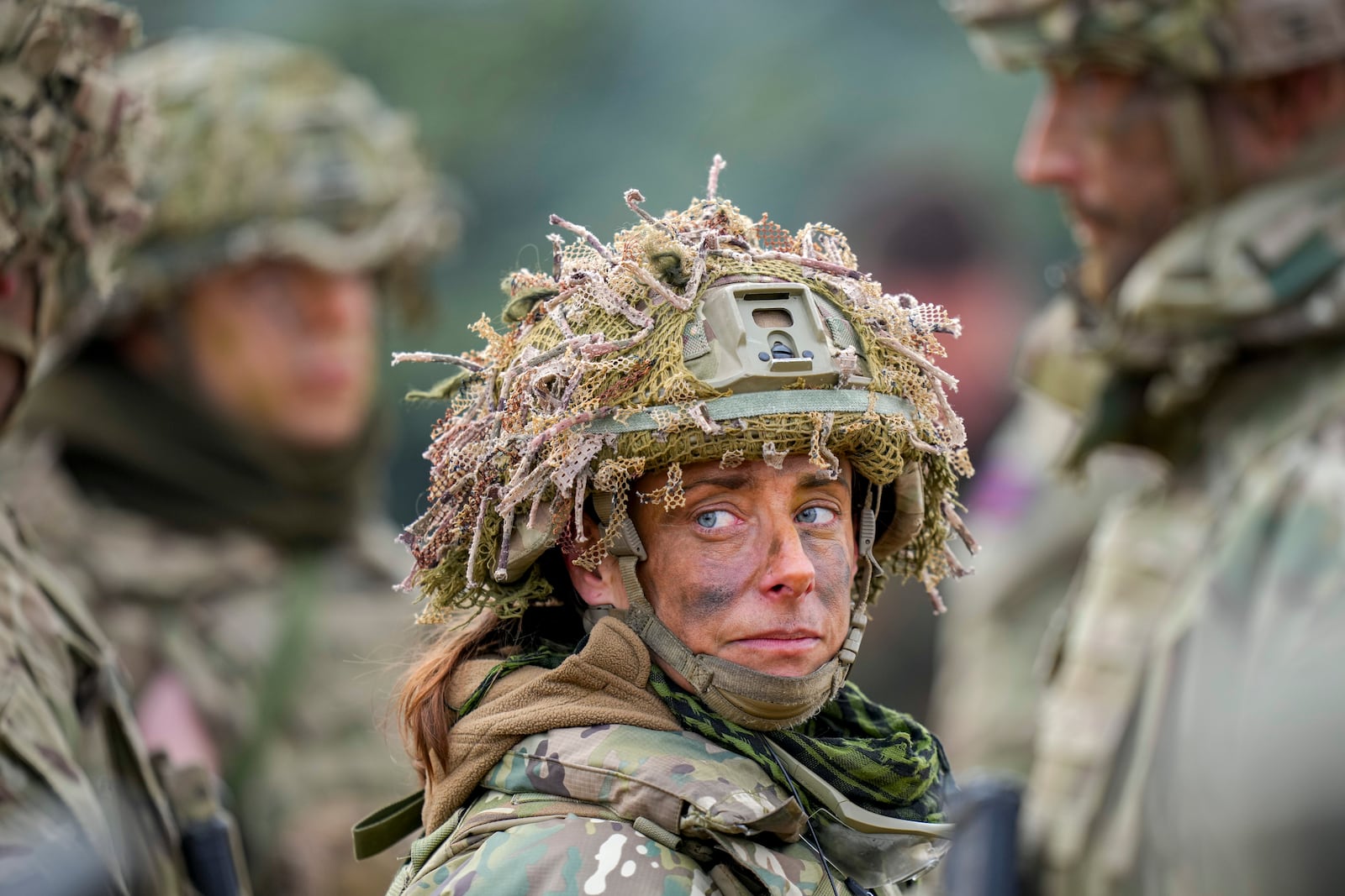 A British servicewoman stands at the end of the Steadfast Dart 2025 exercise, involving some 10,000 troops in three different countries from nine nations and represent the largest NATO operation planned this year, at a training range in Smardan, eastern Romania, Wednesday, Feb. 19, 2025. (AP Photo/Vadim Ghirda)