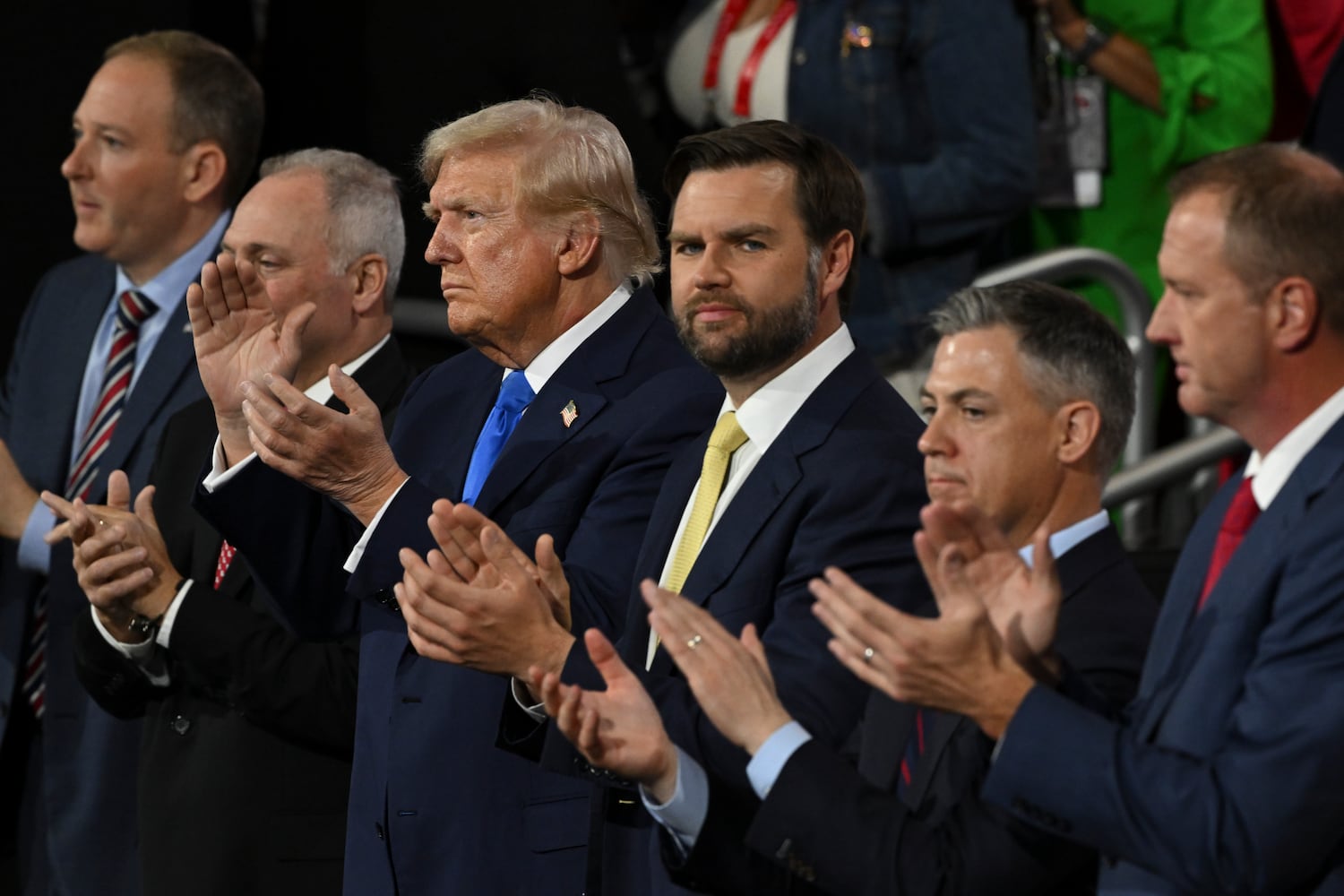 
                        Former President Donald Trump and Sen. JD Vance (R-Ohio), the Republican vice presidential nominee, applaud during the second night of the Republican National Convention at the Fiserv Forum in Milwaukee, Wis., on Tuesday, July 16, 2024. Crime and immigration were the focus of speeches on the second day of the Republican National Convention. (Kenny Holston/The New York Times)
                      