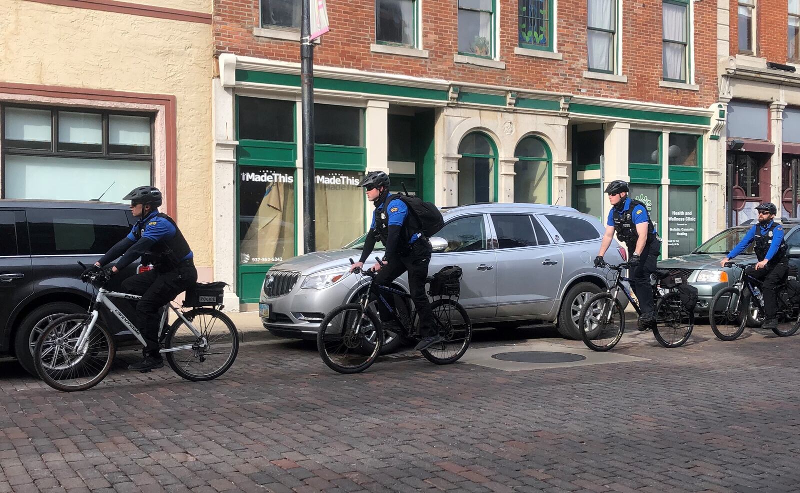 Dayton police trail and monitor a protest in the Oregon District in mid-March. CORNELIUS FROLIK / STAFF