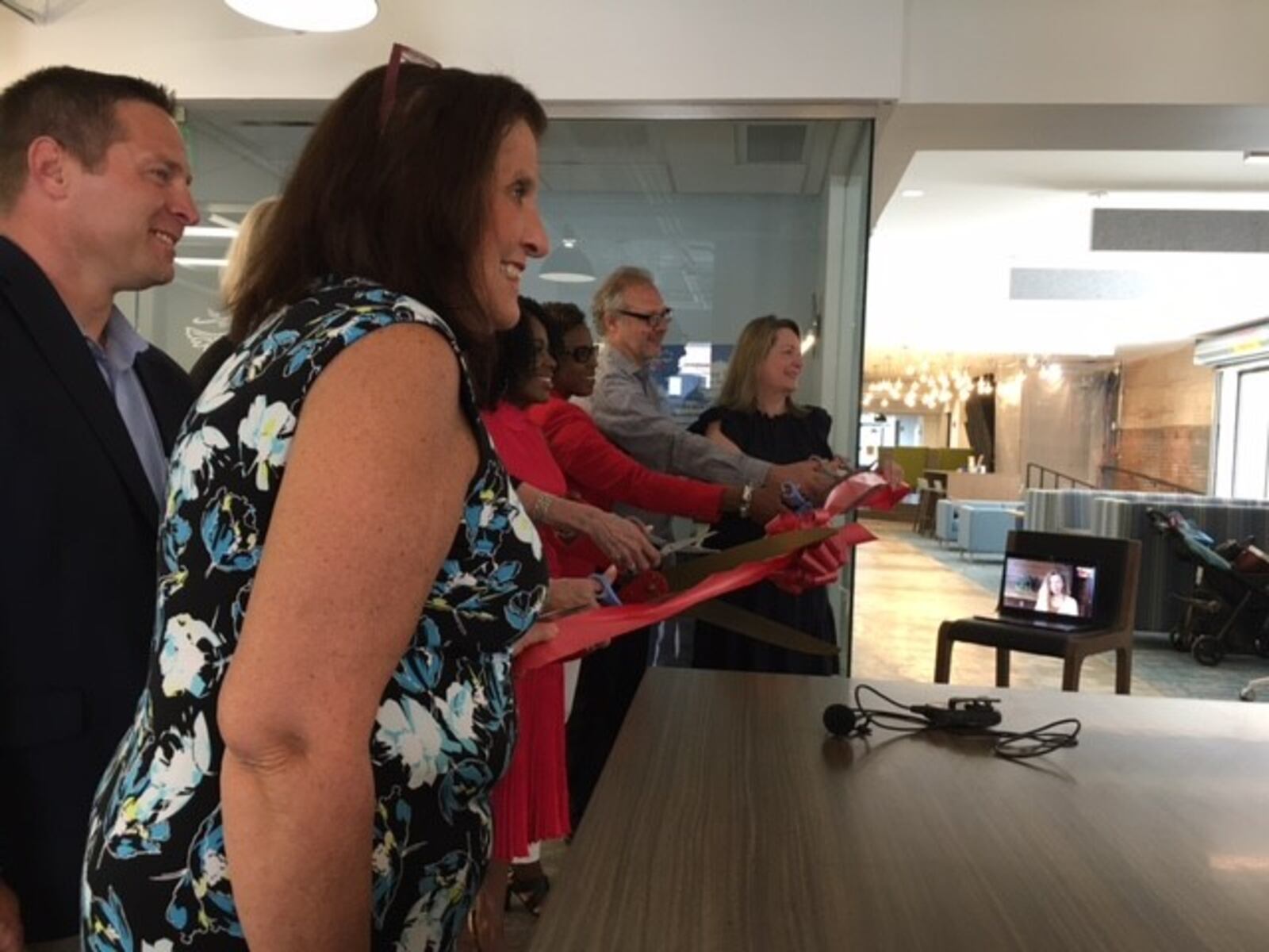 Friends cut the ribbon on the Dayton Arcade office of Aviatra Accelerators. THOMAS GNAU/STAFF