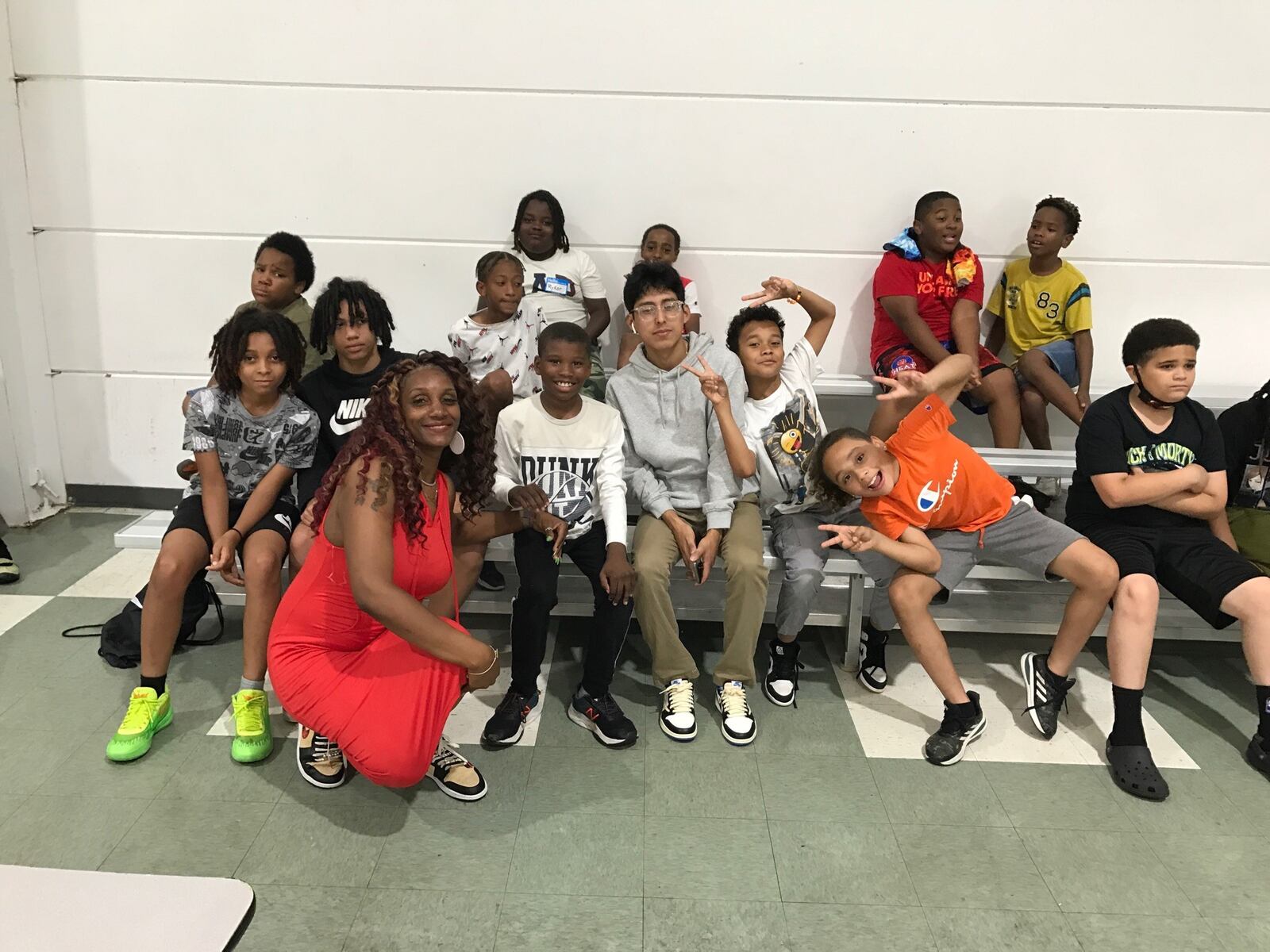 Dione Benson, director of the Dayton Scholars Literacy and Enrichment Program, backed by some of the kids taking part in Thursday’s activities in the gym at Corinthian Baptist Church in West Dayton. Tom Archdeacon/CONTRIBUTED