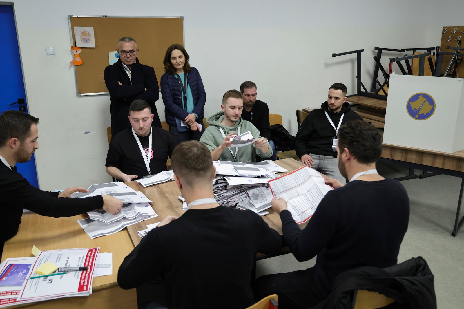 Members of an electoral committee count ballots during parliamentary election, in Pristina, Kosovo, Sunday, Feb. 9, 2025. (AP Photo/Vlasov Sulaj)