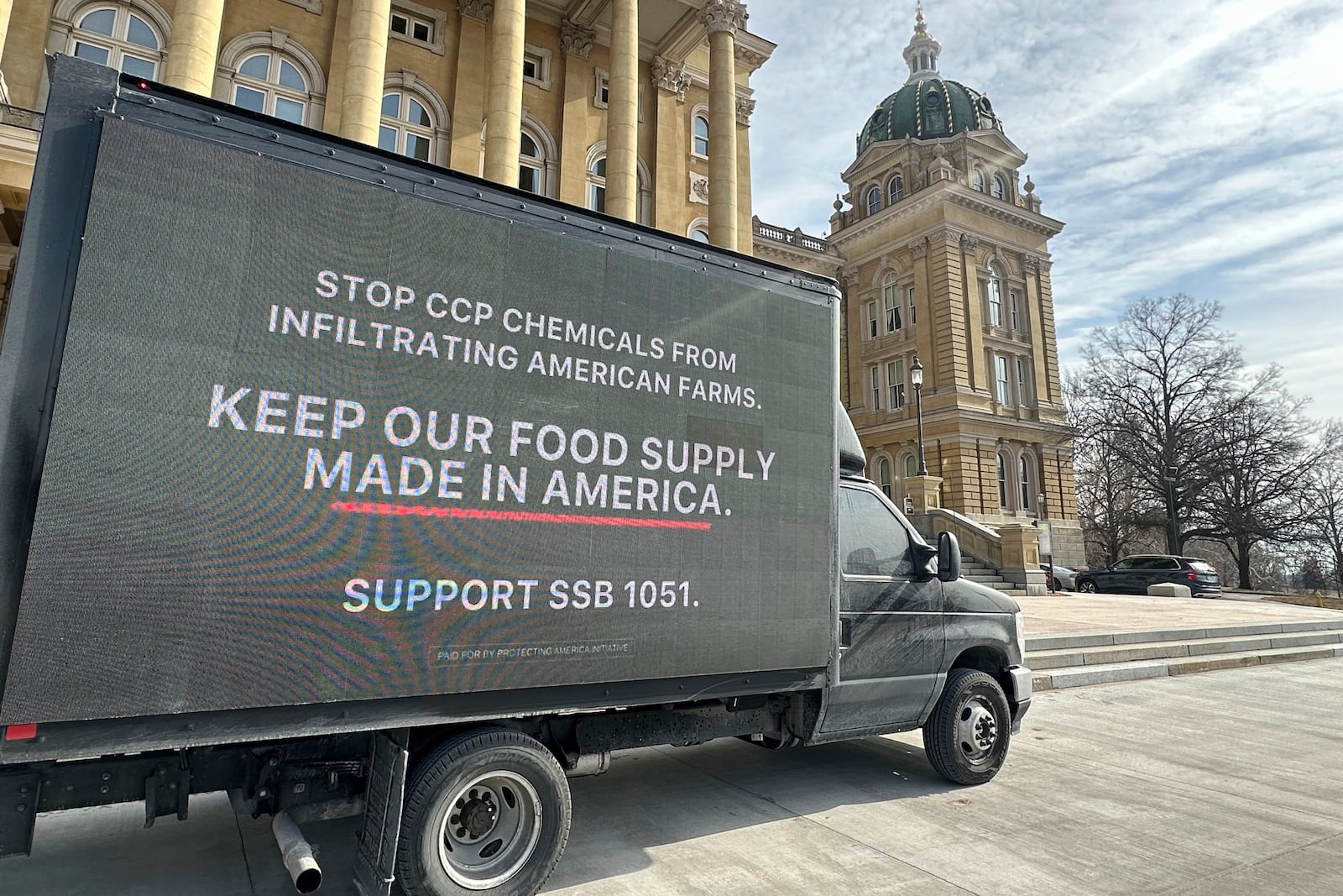 A truck sits outside of the Iowa state capitol building on Monday, Feb. 10, in Des Moines to encourage lawmakers to support a bill that would protect pesticide companies from lawsuits that claim its popular weedkiller causes cancer. (AP Photo/Hannah Fingerhut)