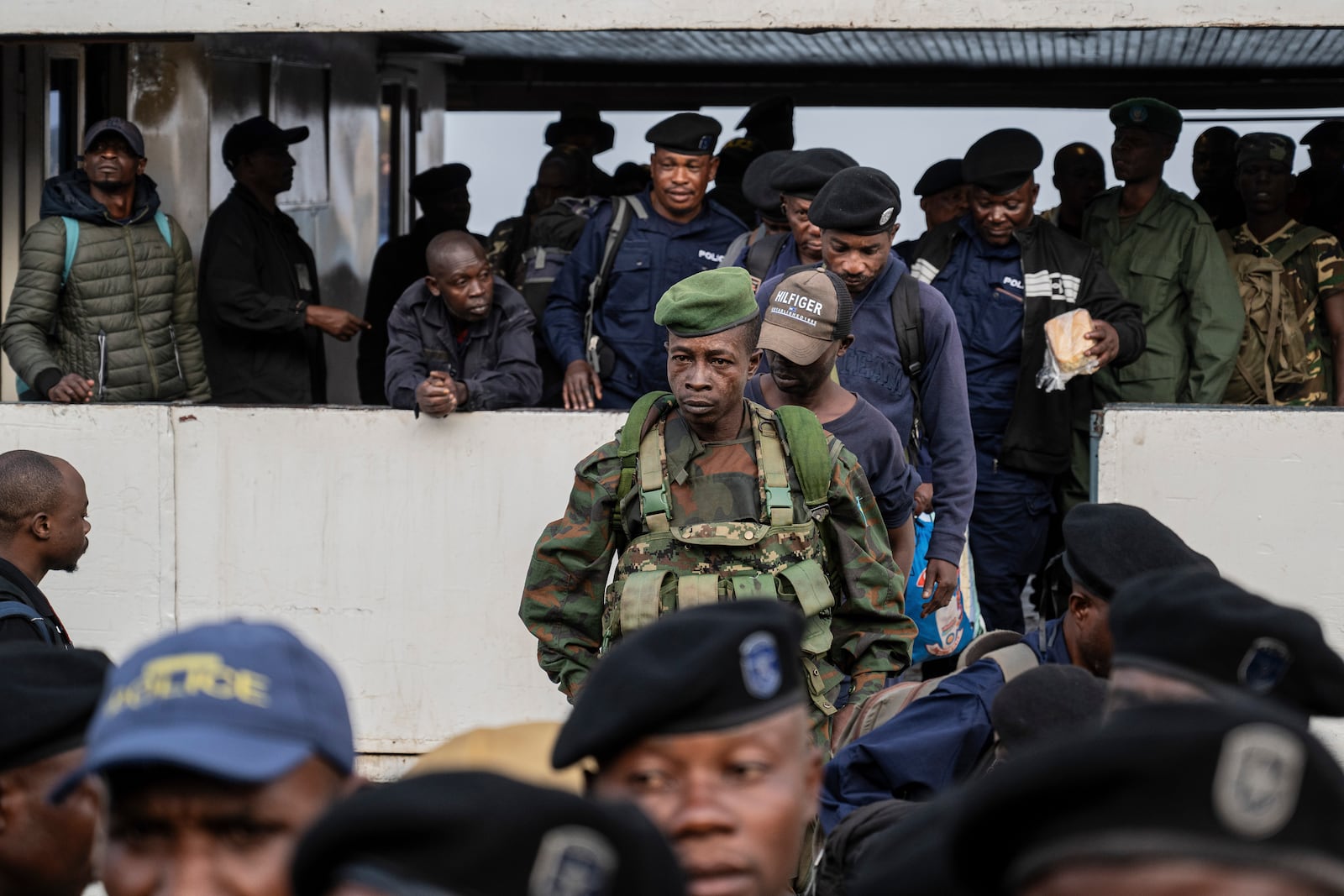 Former members of the Armed Forces of the Democratic Republic of Congo (FARDC) and police officers who allegedly surrendered to M23 rebels arrive in Goma, Congo, Sunday, Feb. 23, 2025. (AP Photo/Moses Sawasawa)