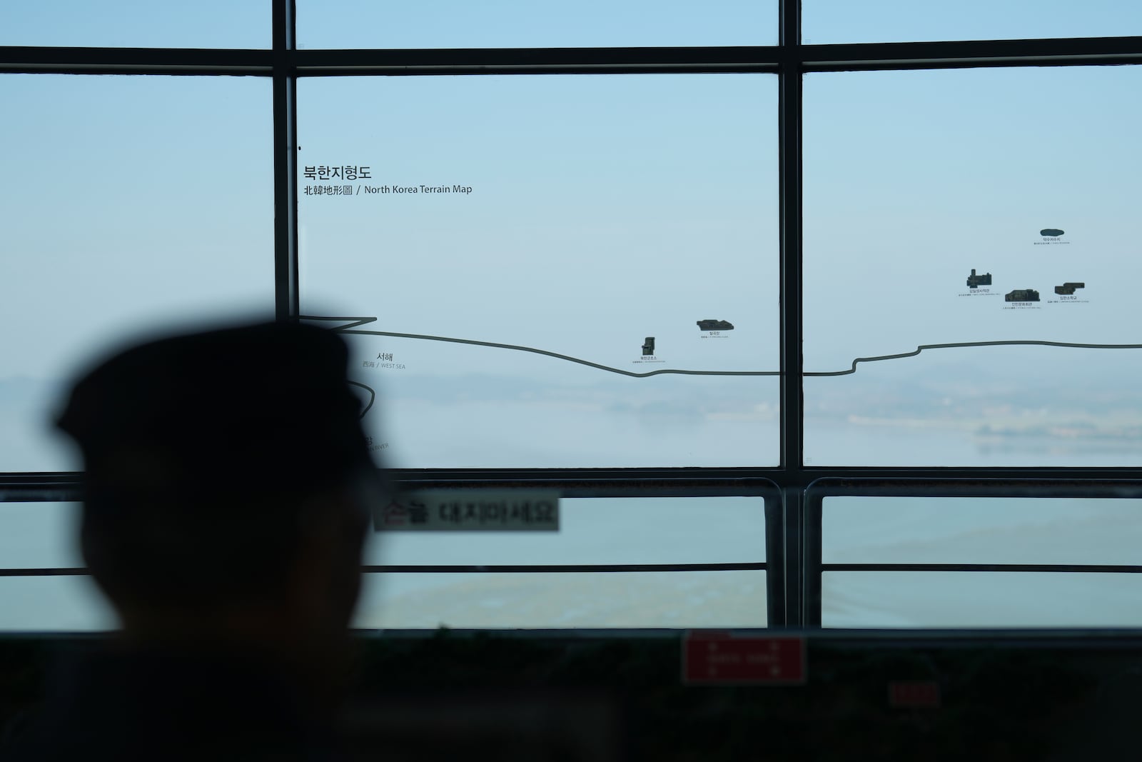 A visitor looks at the North Korean side from the unification observatory in Paju, South Korea, Thursday, Oct. 31, 2024. (AP Photo/Lee Jin-man)