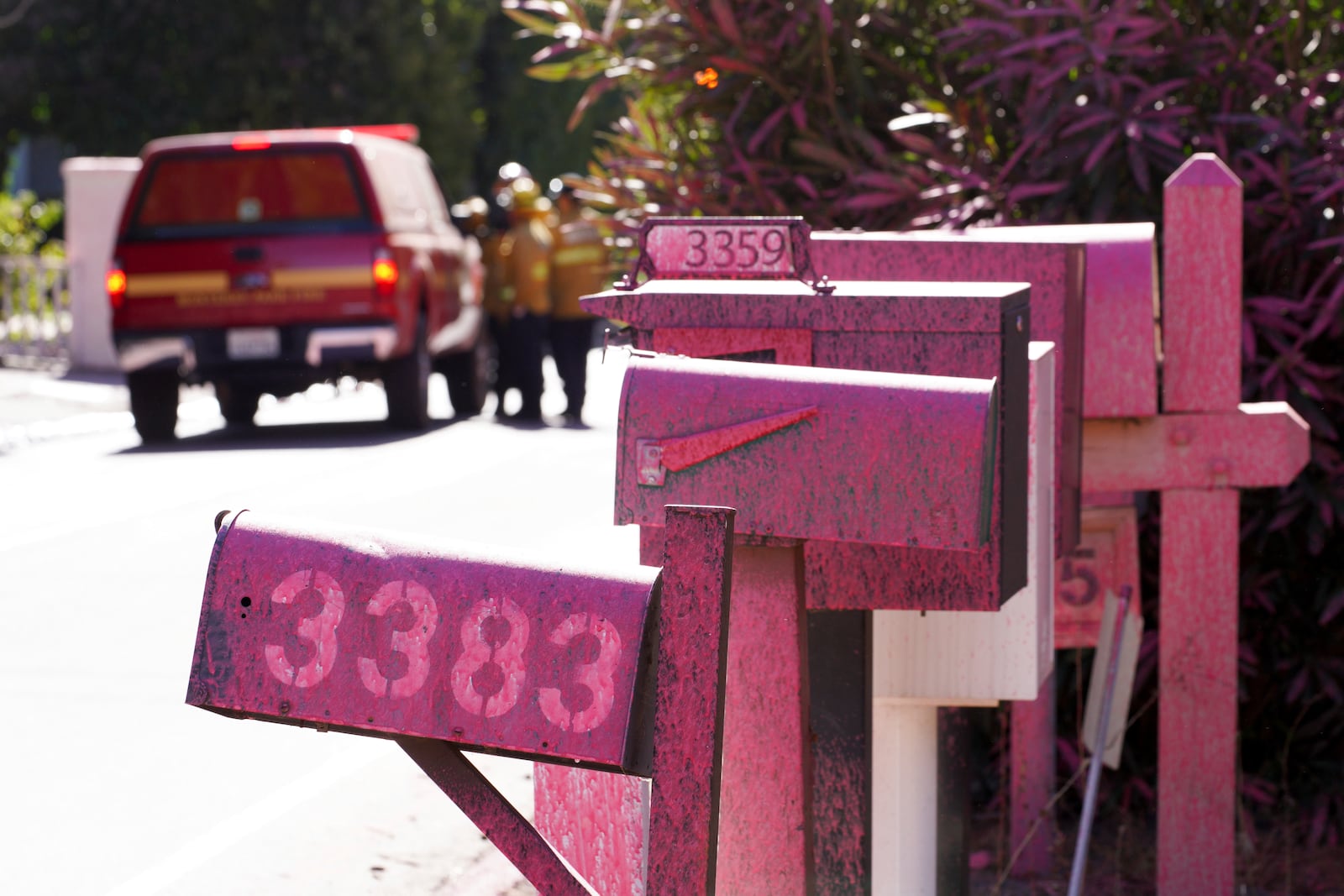 Retardant covers mailboxes after crews battled the Palisades Fire in Mandeville Canyon Monday, Jan. 13, 2025, in Los Angeles. (AP Photo/Richard Vogel)