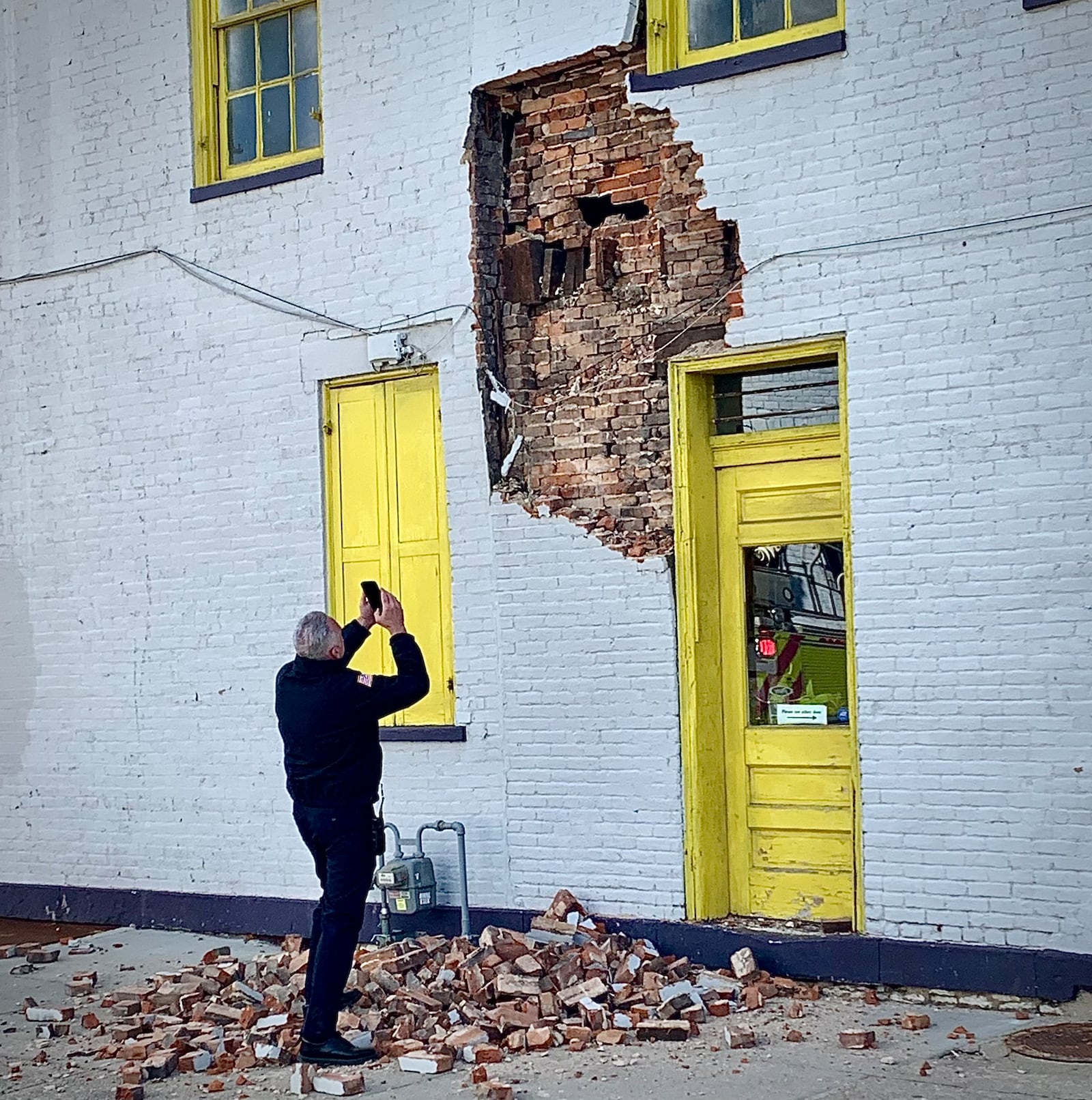 Part of the wall on an Oregon District building at E. 5th and Jackson streets collapsed Monday, March 24, 2025, leaving a pile of bricks on the sidewalk. MARSHALL GORBY, STAFF