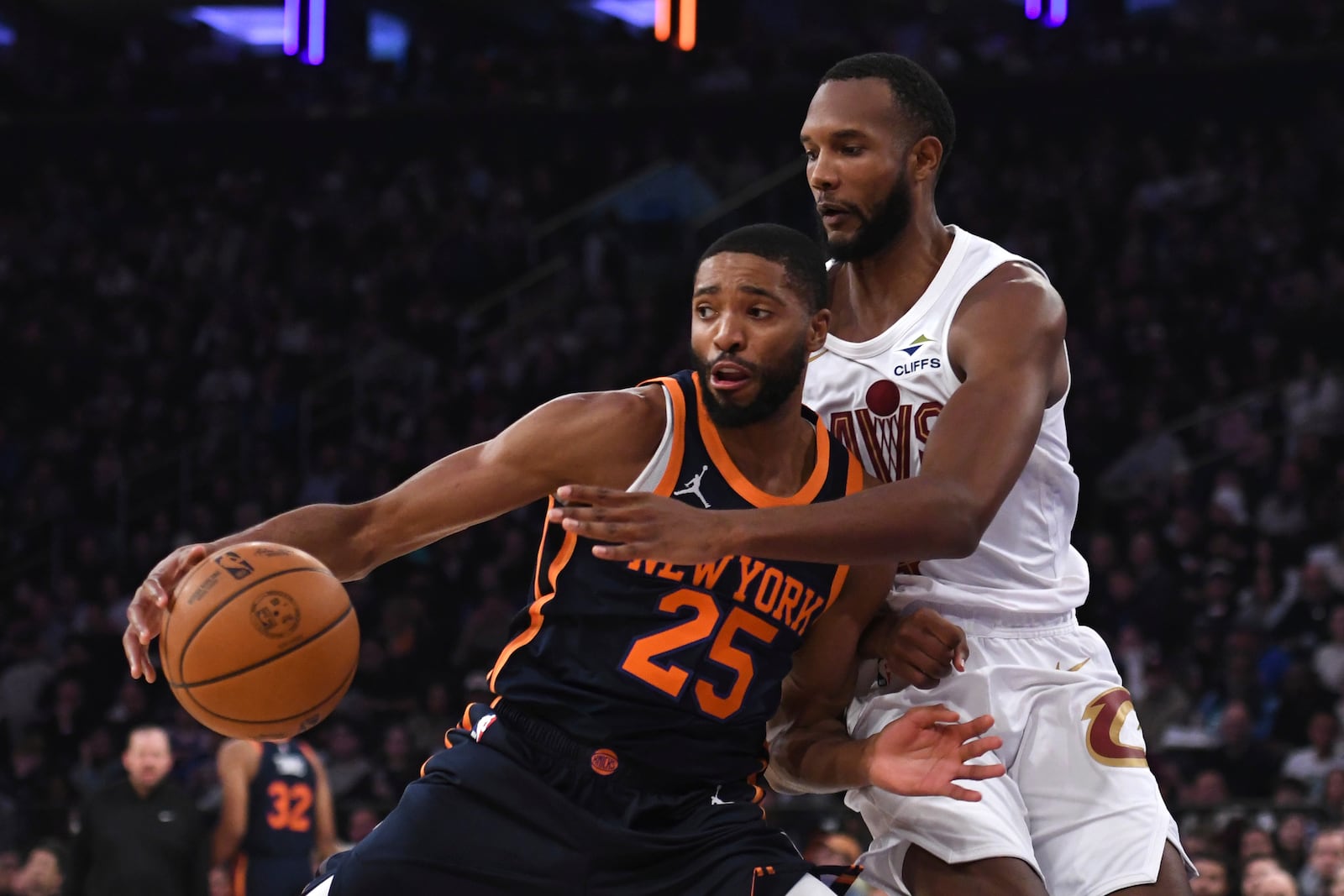 New York Knicks' Mikal Bridges, left, attempts to dribble the ball past Cleveland Cavaliers' Evan Mobley, right, during the first half of an NBA basketball game, Monday, Oct. 28, 2024, in New York. (AP Photo/Pamela Smith)