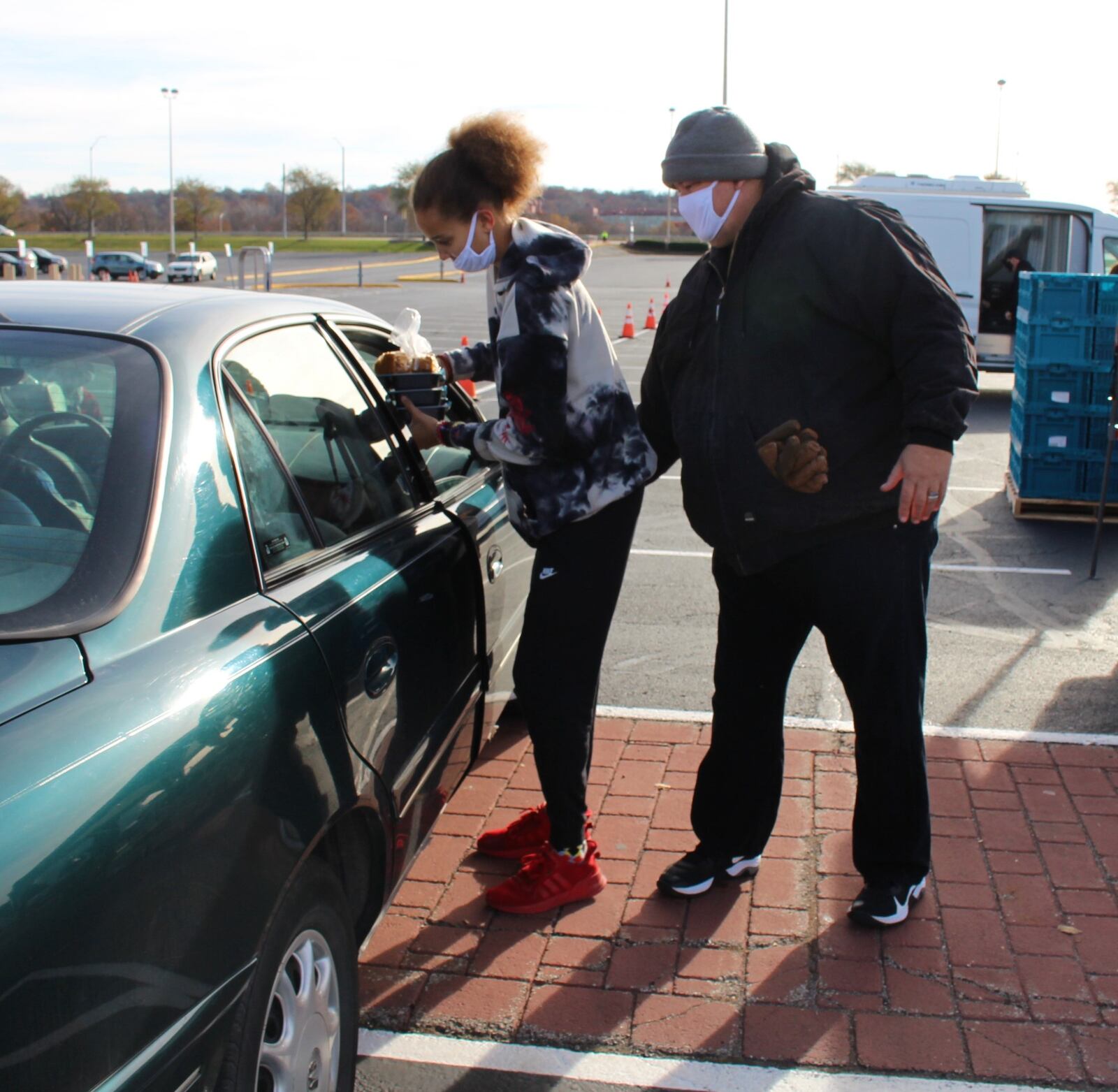 Paul Crozier and his daughter, Paige, volunteered at the Miami Valley Meals Thanksgiving giveaway at UD Arena Wednesday, handing out a portion of the 15,000 meals distributed ahead of the holiday. AIMEE HANCOCK/STAFF