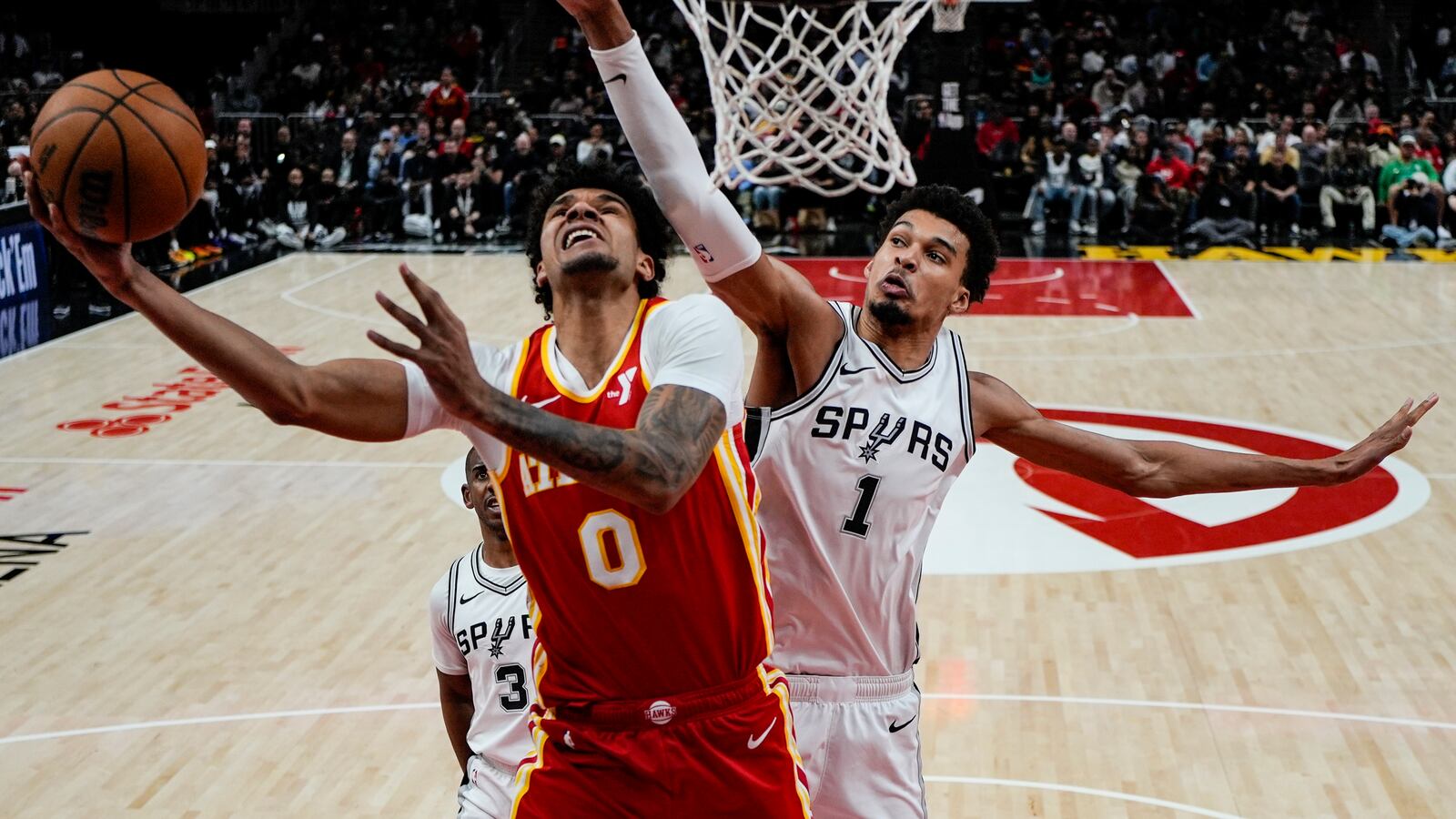 =h0= shoots against San Antonio Spurs center Victor Wembanyama (1) during the second half of an NBA basketball game, Wednesday, Feb. 5, 2025, in Atlanta. (AP Photo/Mike Stewart)