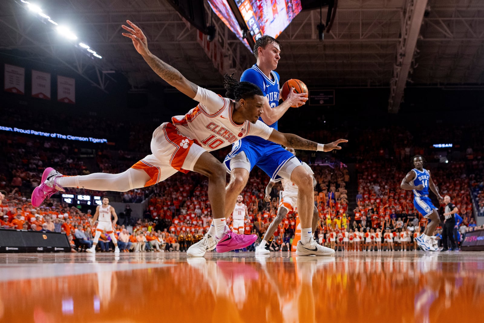 Clemson guard Del Jones (10) tries to steal the ball from Duke guard Cooper Flagg (2) during the second half of an NCAA college basketball game on Saturday, Feb. 8, 2025, in Clemson, S.C. (AP Photo/Scott Kinser)