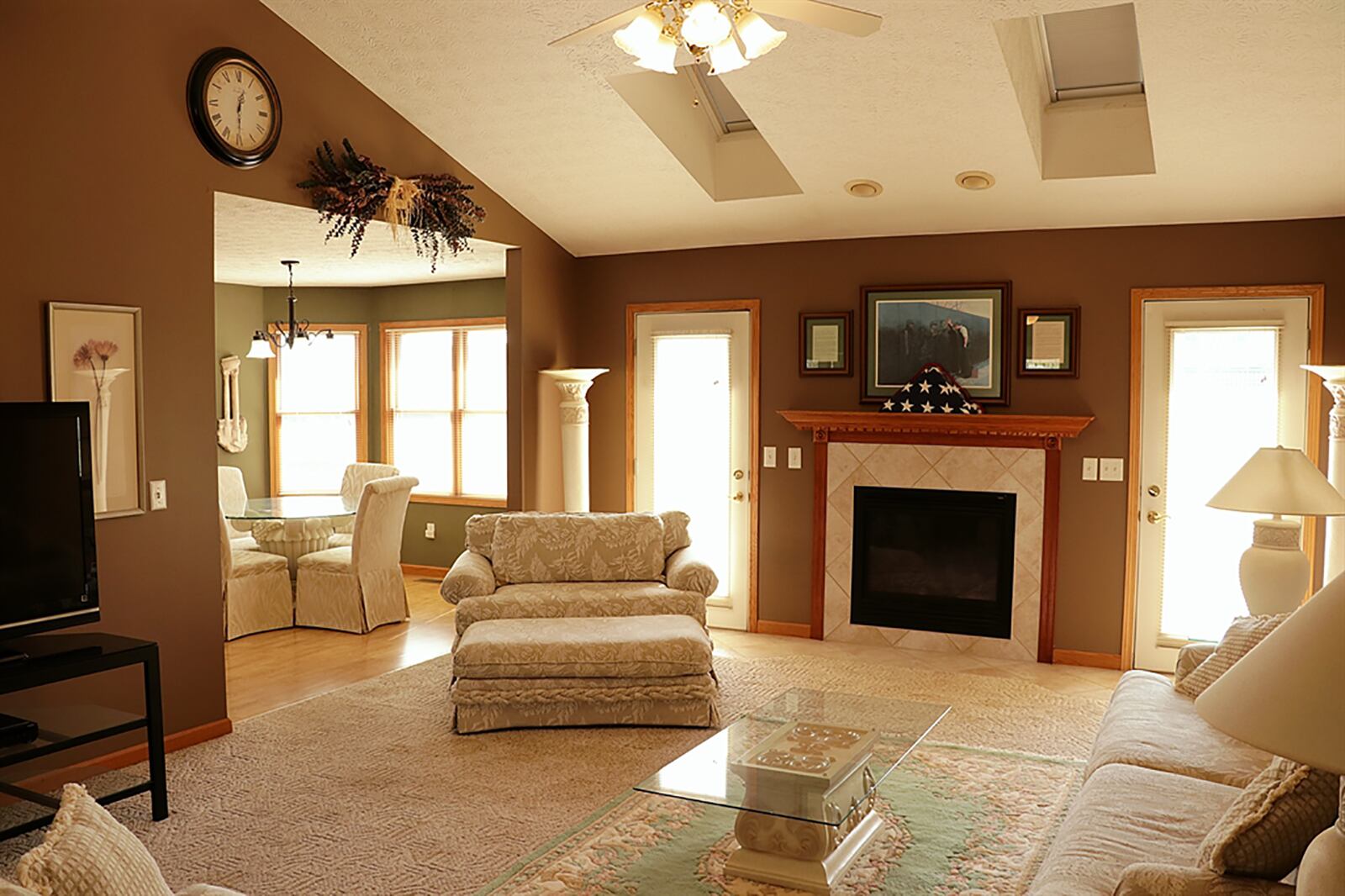 Ceramic-tile flooring fills a spacious entry area and wraps around the great room, creating entry pads at the two rear glass doors that open to the backyard, wooden deck. The doors flank a gas fireplace. CONTRIBUTED PHOTO BY KATHY TYLER