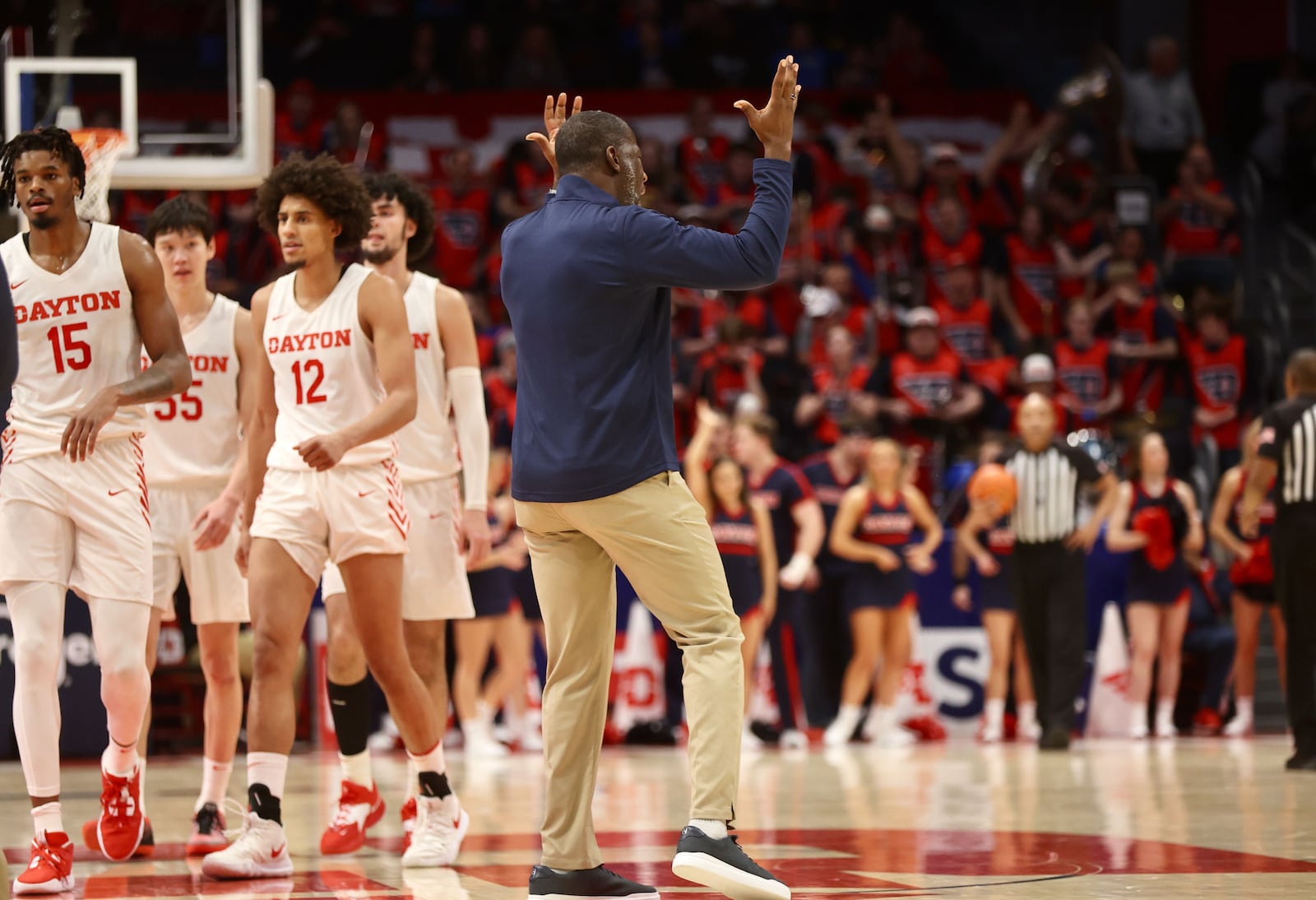 Dayton's Anthony Grant tries to pump up the crowd during a timeout against Duquesne on Wednesday, Dec. 28, 2022, at UD Arena. David Jablonski/Staff