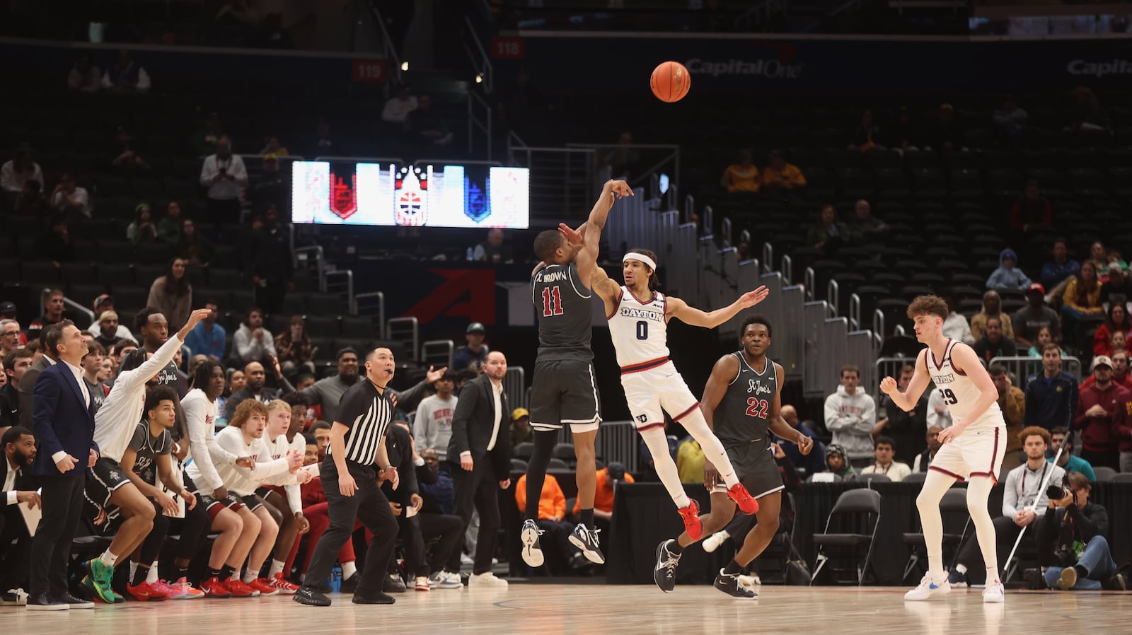 Xzayvier Brown, of Saint Joseph’s, makes a 3-pointer in overtime against Dayton on Friday, March 14, 2025, in the quarterfinals of the Atlantic 10 Conference tournament at Capital One Arena in Washington, D.C. David Jablonski/Staff