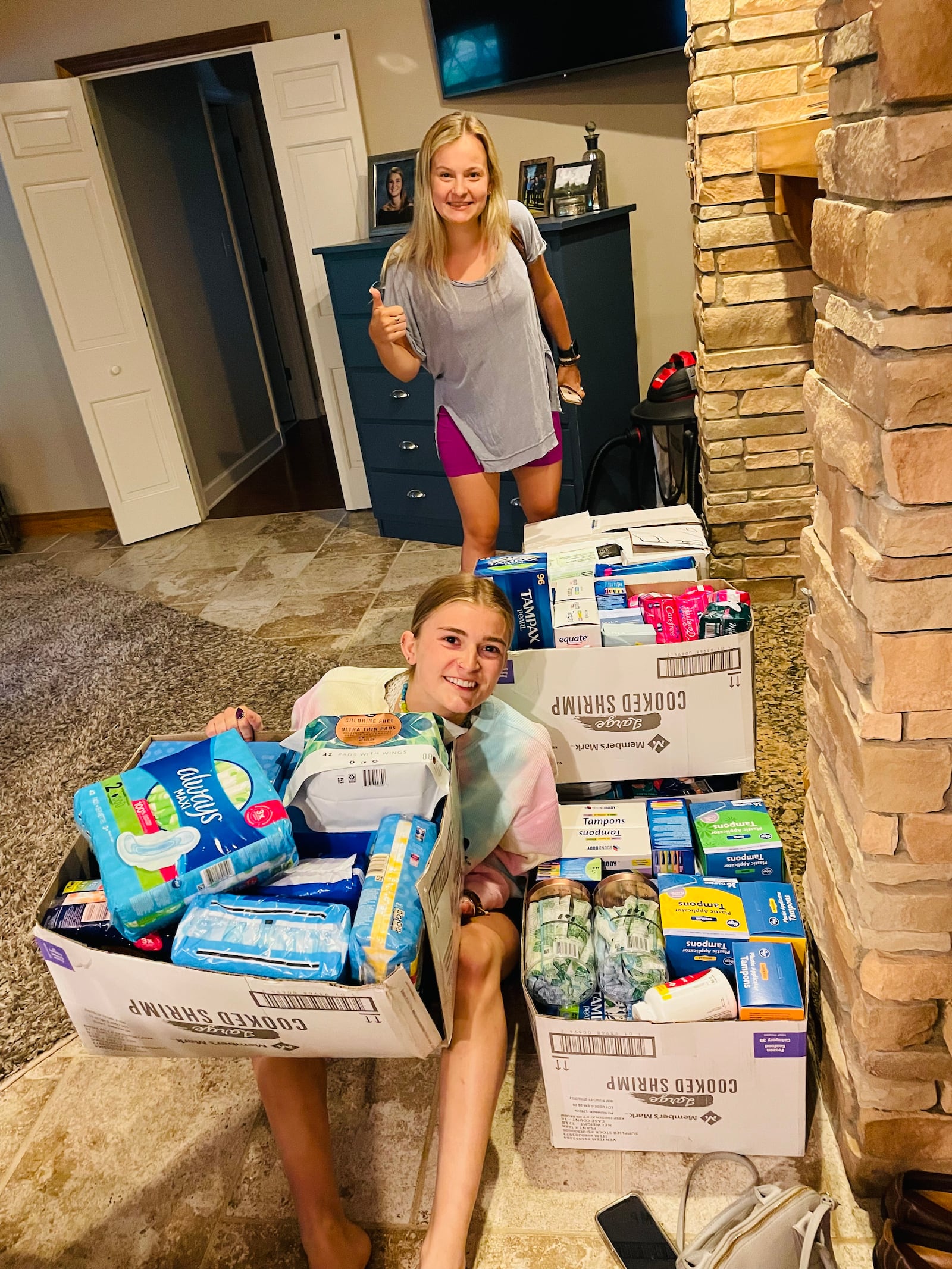 Zoe Waller and Ryann Mescher, Femme Aid Collaborative founders, with community donations of menstrual products. CONTRIBUTED