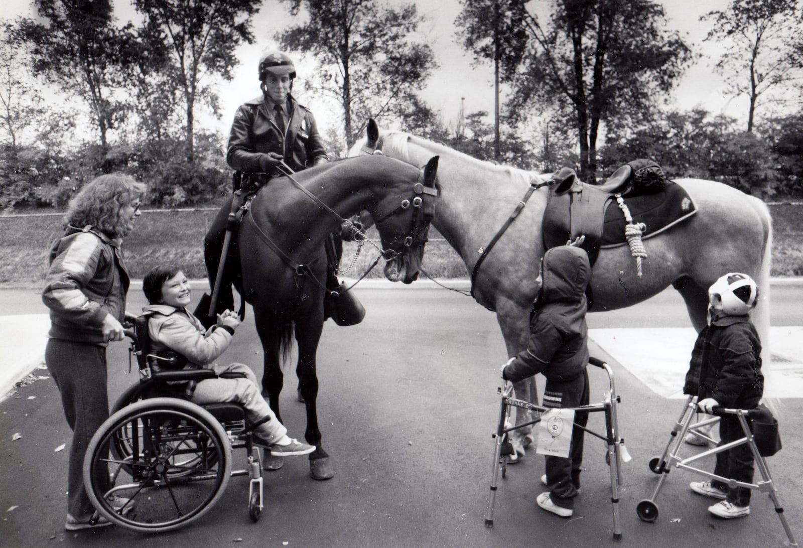 Students Kenny Kelly, Tom Finfrock and Christopher Moran and their teacher, Carol Suddath get a close looks at horses with the Dayton Police Mounted United and Police Officer Tim Zimmer. DAYTON DAILY NEWS ARCHIVE