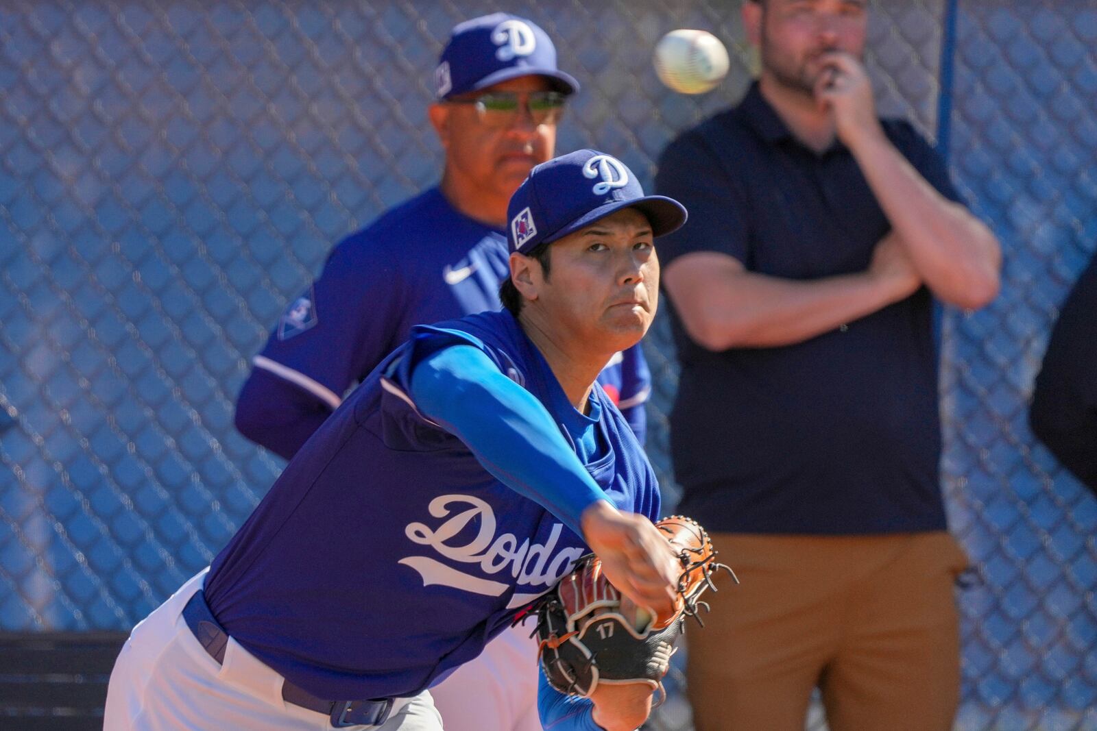 Los Angeles Dodgers two-way player Shohei Ohtani (17) throws during a spring training baseball practice, Tuesday, Feb. 25, 2025, in Phoenix. (AP Photo/Darryl Webb)