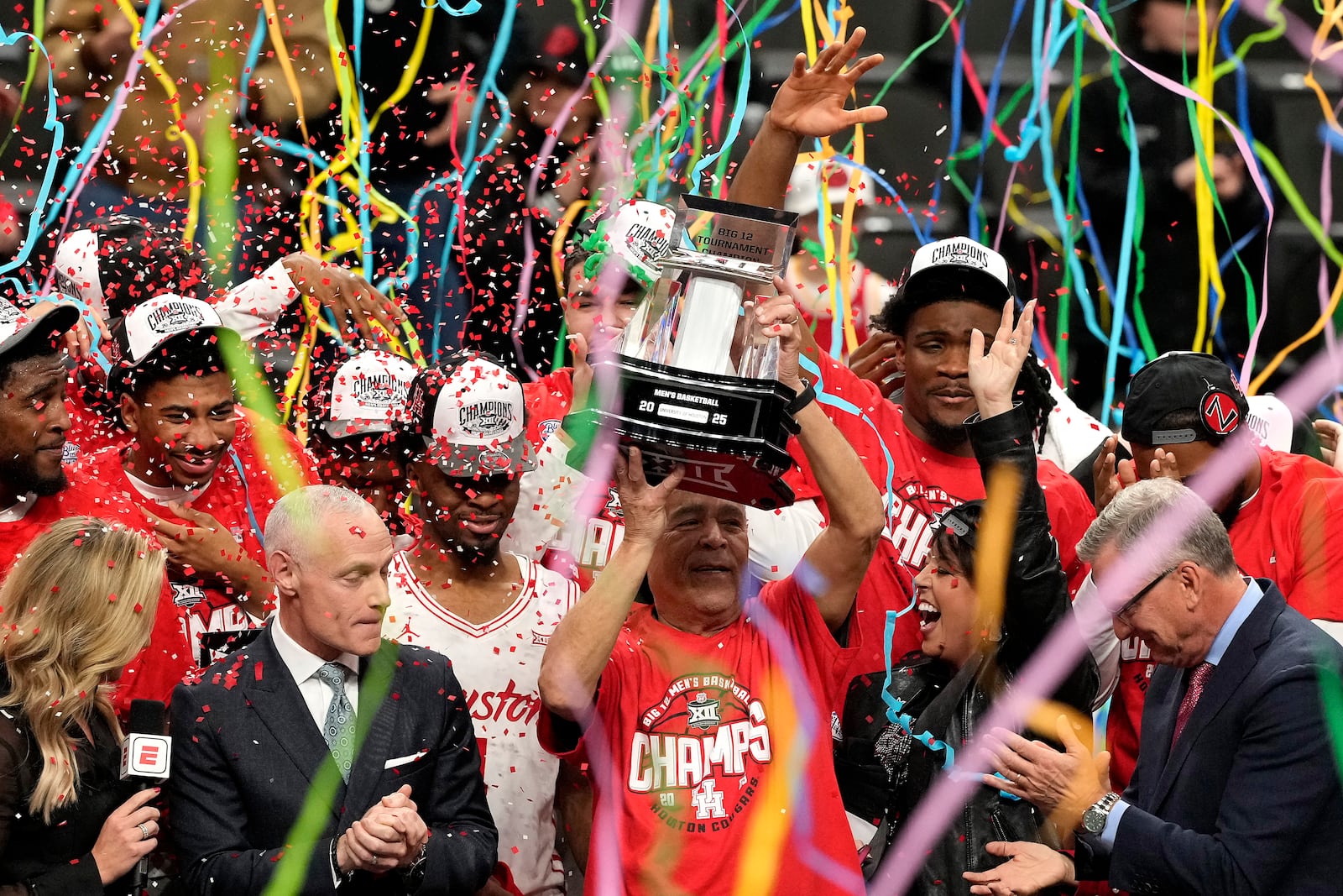 Houston head coach Kelvin Sampson lifts the trophy after winning an NCAA college basketball game against Arizona for the championship in the Big 12 Conference tournament, Saturday, March 15, 2025, in Kansas City, Mo. (AP Photo/Charlie Riedel)