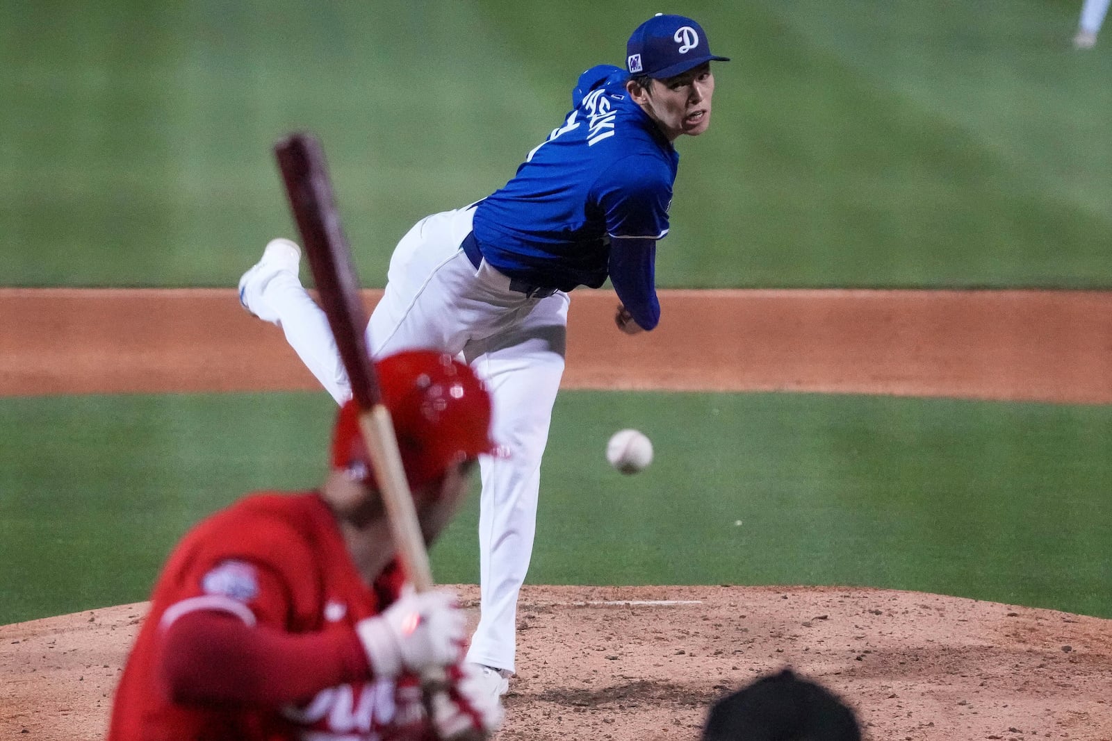 Los Angeles Dodgers pitcher Roki Sasaki (11) throws during the sixth inning of a spring training baseball game against the Cincinnati Reds, Tuesday, March. 4, 2025, in Phoenix. (AP Photo/Darryl Webb)