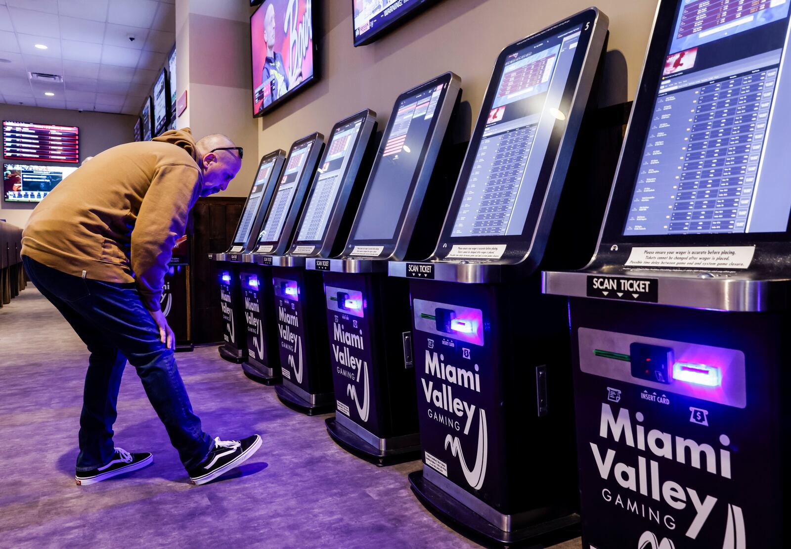 Chris Clement uses one of the kiosks in the sports betting area Friday, Dec. 15, 2023 at Miami Valley Gaming on OH 63 in Warren County. NICK GRAHAM/STAFF