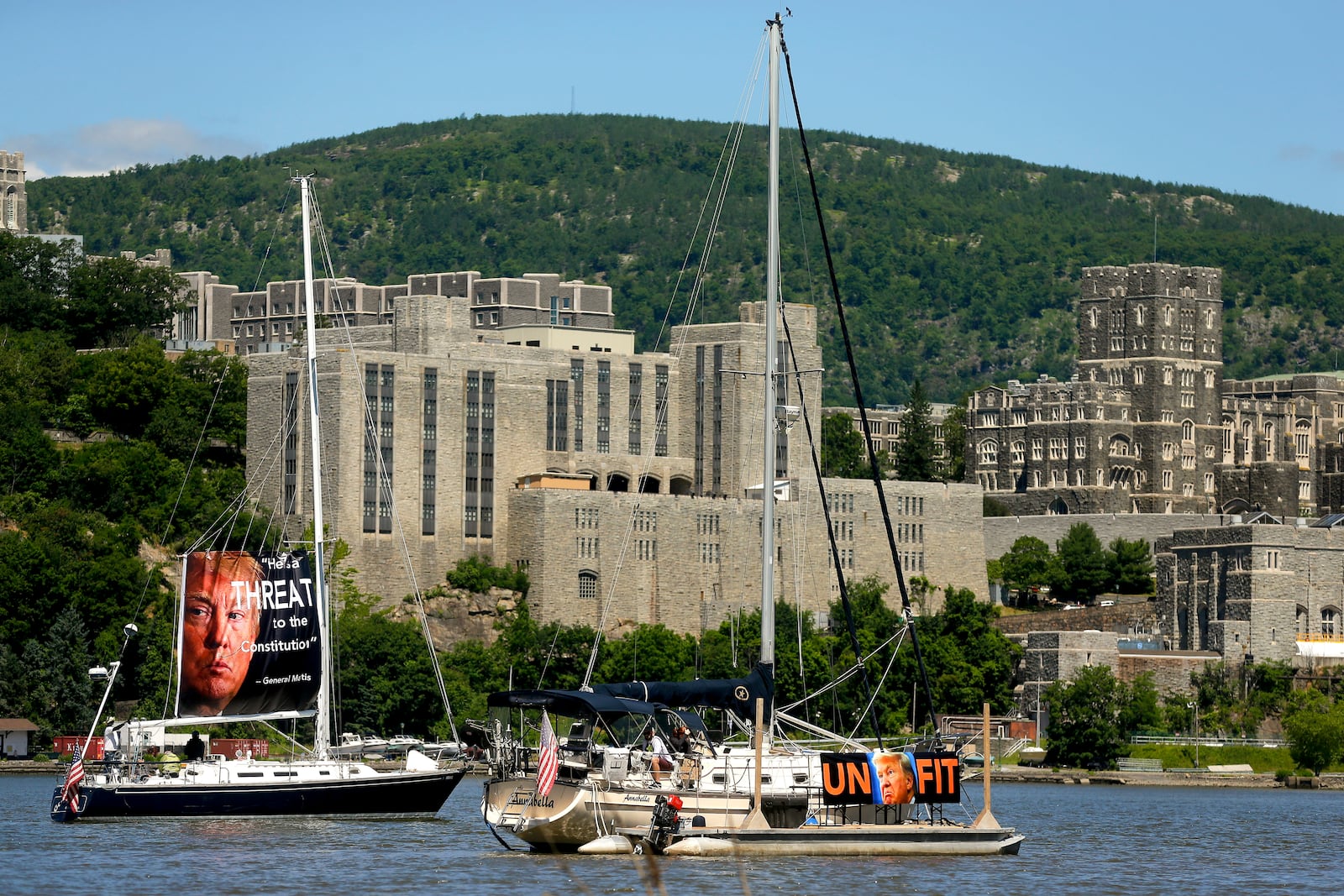 FILE - Demonstrators in sailboats protest on the Hudson River, Saturday, June 13, 2020, in Garrison, N.Y., as President Donald Trump gives his commencement address across the river during West Point's graduation ceremony. (AP Photo/Julie Jacobson, File)