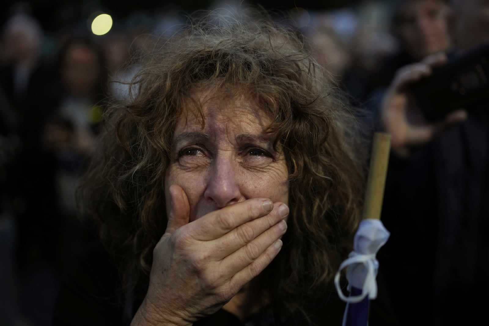 Relatives and friends of people killed and abducted by Hamas and taken into Gaza, react to the news of the hostages' release, as they gather in Tel Aviv, Israel on Sunday, Jan. 19, 2025. (AP Photo/Oded Balilty)