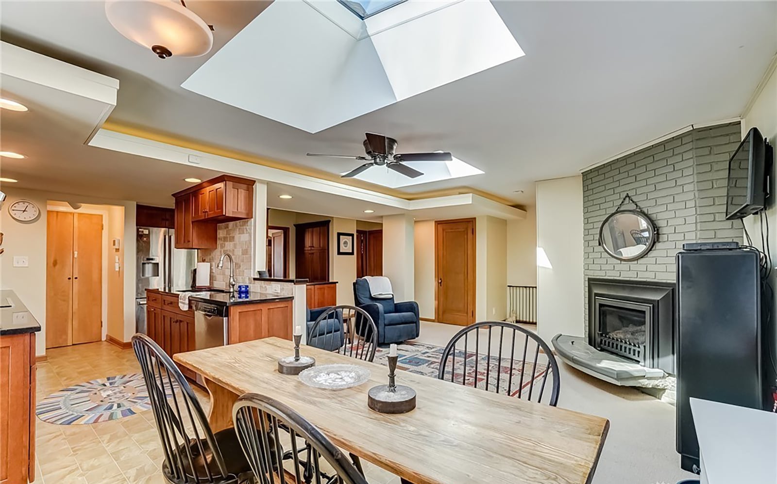 The open concept kitchen has been updated with wood cabinets, skylights and high end appliances. There is a fireplace in the attached family room.