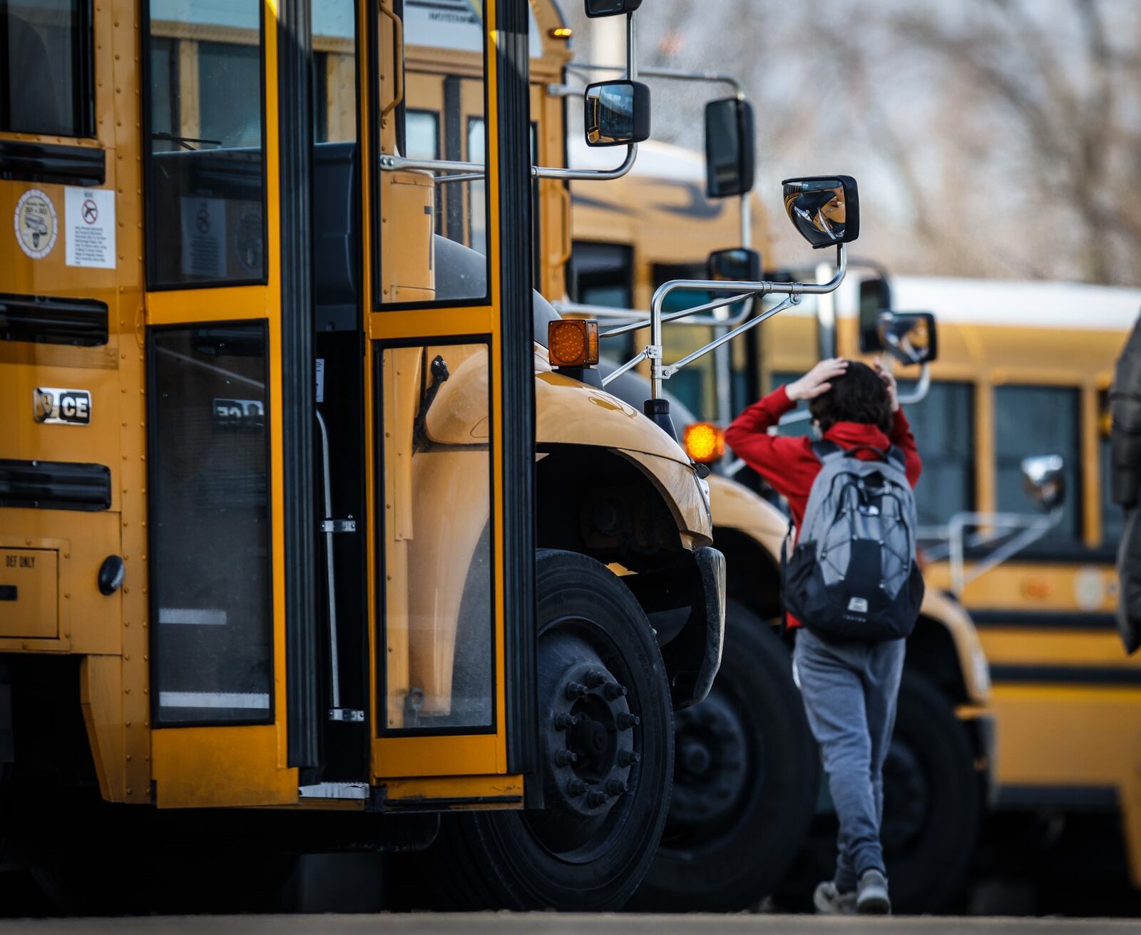 Students at Van Buren Middle School in Kettering load onto their buses for the ride home Friday Jan. 21, 2022. JIM NOELKER/STAFF