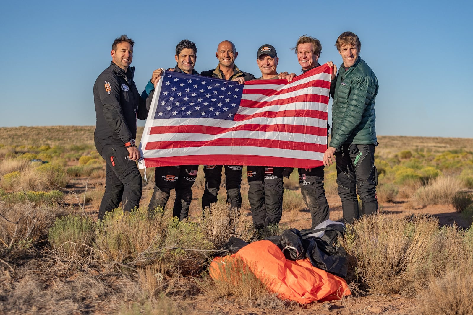 Post jump just after breaking the world record and landing in the New Mexico desert. From left: CMSgt. Brandon Daugherty, MSgt. Rob Dieguez, CMSgt. (Ret) Chris Lais, MSgt. (Ret) Jimmy Petrolia, Larry Connor. Chris Peterson/CONTRIBUTED