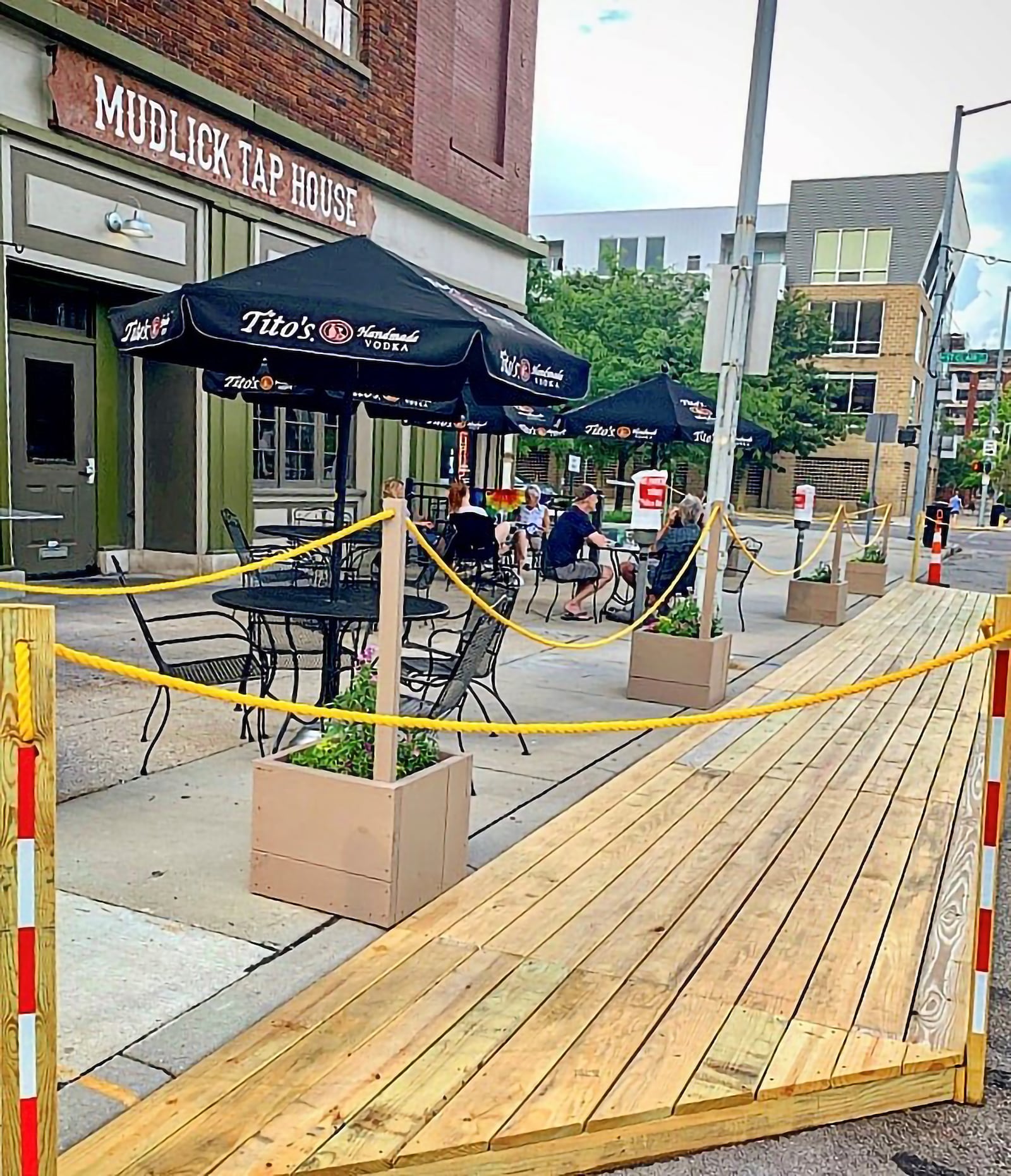 A sidewalk extension allows expanded outdoor dining at downtown Dayton’s Mudlick Tap House.