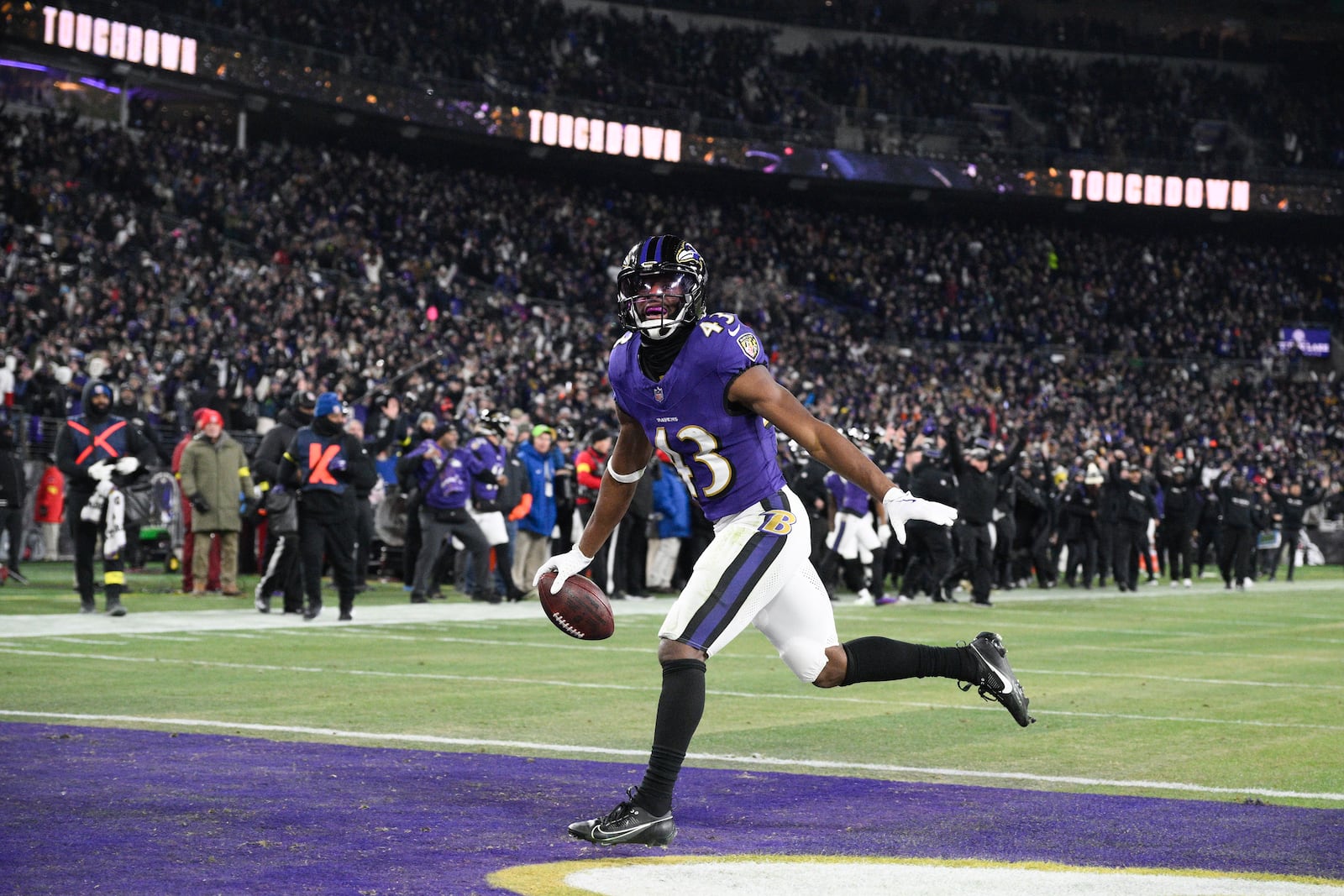 Baltimore Ravens running back Justice Hill scores on a pass from quarterback Lamar Jackson during the first half of an NFL wild-card playoff football game against the Pittsburgh Steelers, Saturday, Jan. 11, 2025, in Baltimore. (AP Photo/Nick Wass)