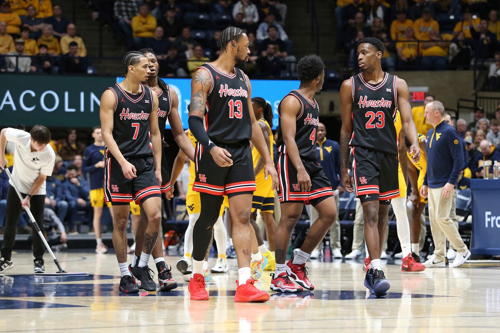 Houston players walk on court during the first half of an NCAA college basketball game against West Virginia, Wednesday, Jan. 29, 2025, in Morgantown, W.Va. (AP Photo/Kathleen Batten)