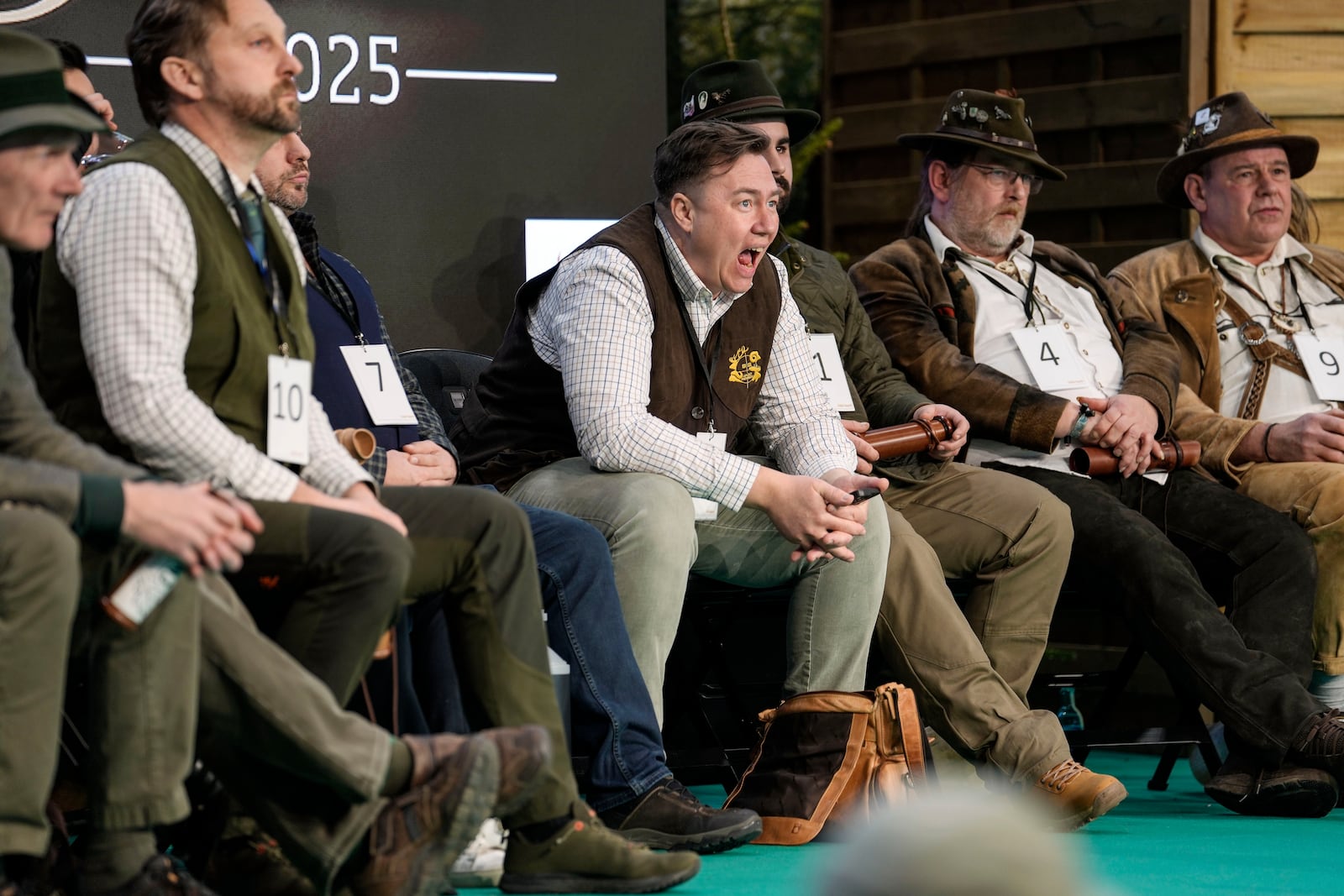 The later winner Fabian Menzel, center, exercises as he waits to perform to imitate a stag in heat during the German Championship of Deer-Calling at the hunting fair in Dortmund, Germany, Friday, Jan. 31, 2025. (AP Photo/Martin Meissner)