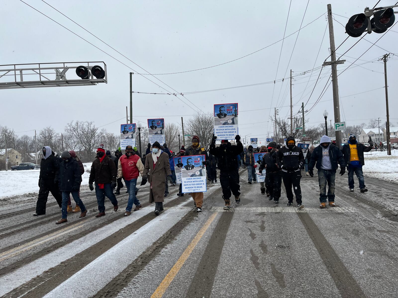 A march to honor Martin Luther King’s legacy began at 9:40 a.m. Jan. 17, 2022 on West Third Street in Dayton. It included hundreds of people who walked through the Wright Dunbar business district, across the new Third Street Bridge and gathered on the Sinclair Community College campus, where there was a presentation featuring several speakers. CORY FROLIK/STAFF