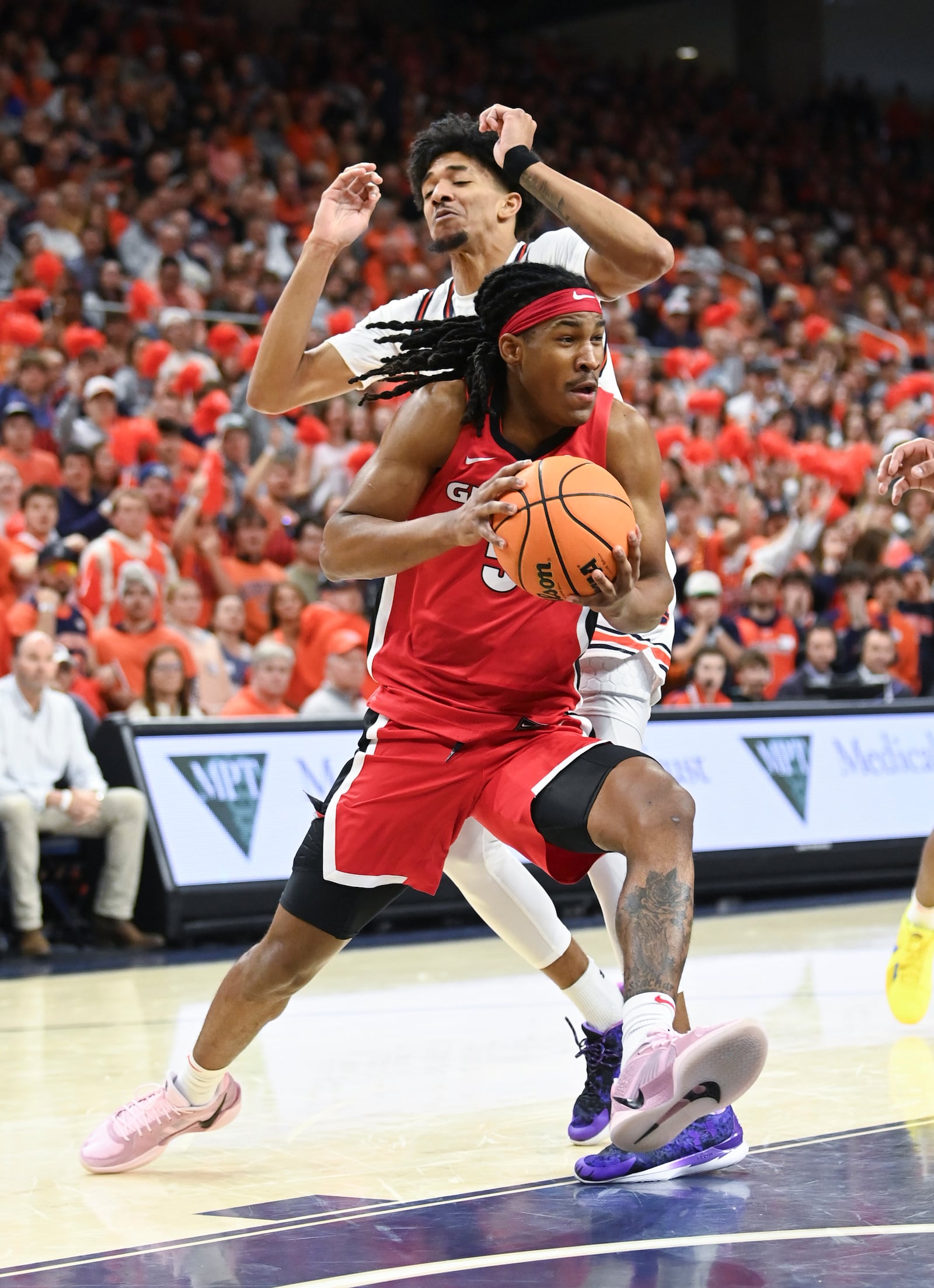 Georgia guard Silas Demary (5) drives past Auburn forward/guard Chad Baker-Mazara (10) during the first half an NCAA college basketball game Saturday, Feb. 22, 2025, in Auburn, Ala. (AP Photo/Julie Bennett)