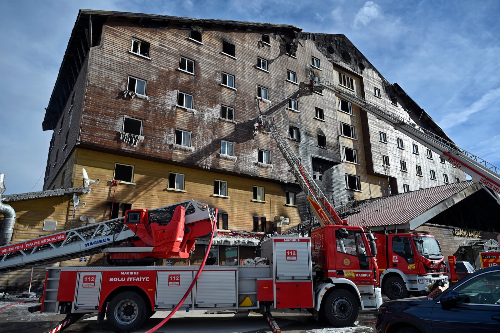 Firefighters work after a fire broke out at a hotel in the ski resort of Kartalkaya, located in the Bolu province, northwest Turkey, Tuesday, Jan. 21, 2025. (Mert Gokhan Koc/dia Photo via AP)