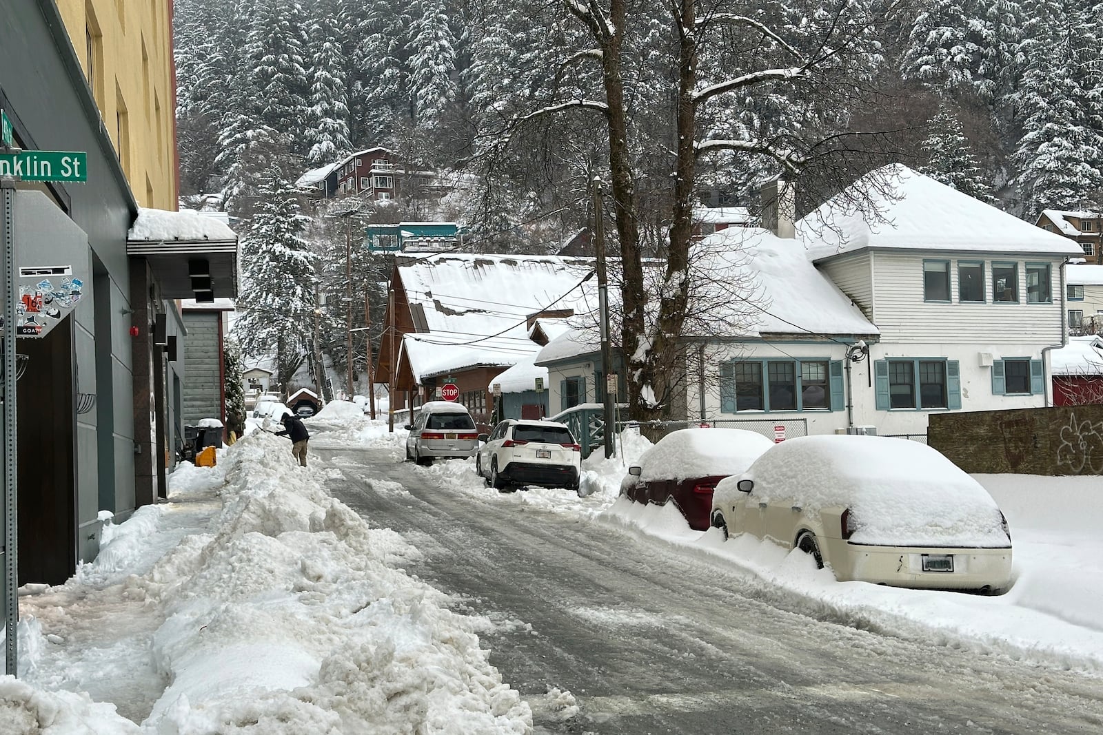 A man shovels snow in downtown Juneau, Alaska, on Monday, Dec. 2, 2024. (AP Photo/Becky Bohrer)